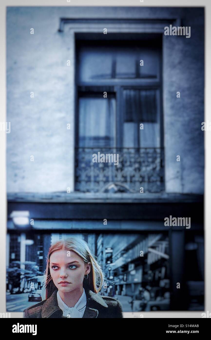 Beautiful woman under a window looking sideways - Smartphone Captured Stock Image