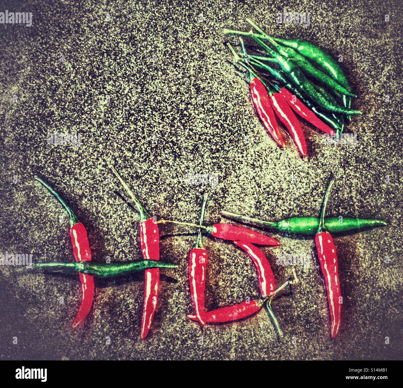 Green and red hot chilli peppers, spelling the word Hot - Smartphone Captured Stock Image