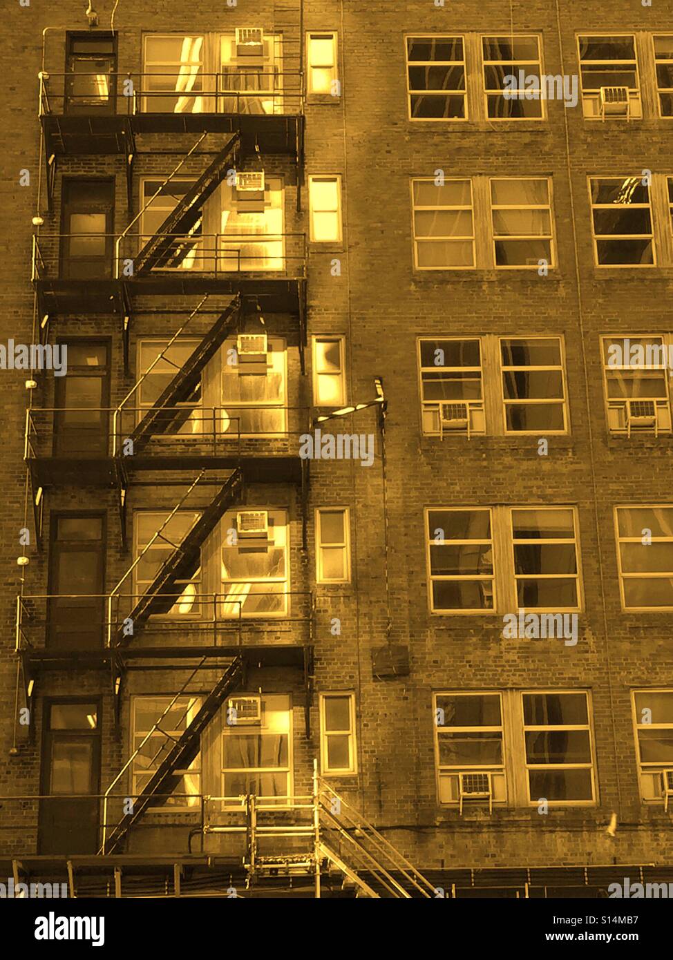 Sepia - exterior fire escape stairway on an old office building - Smartphone Captured Stock Image