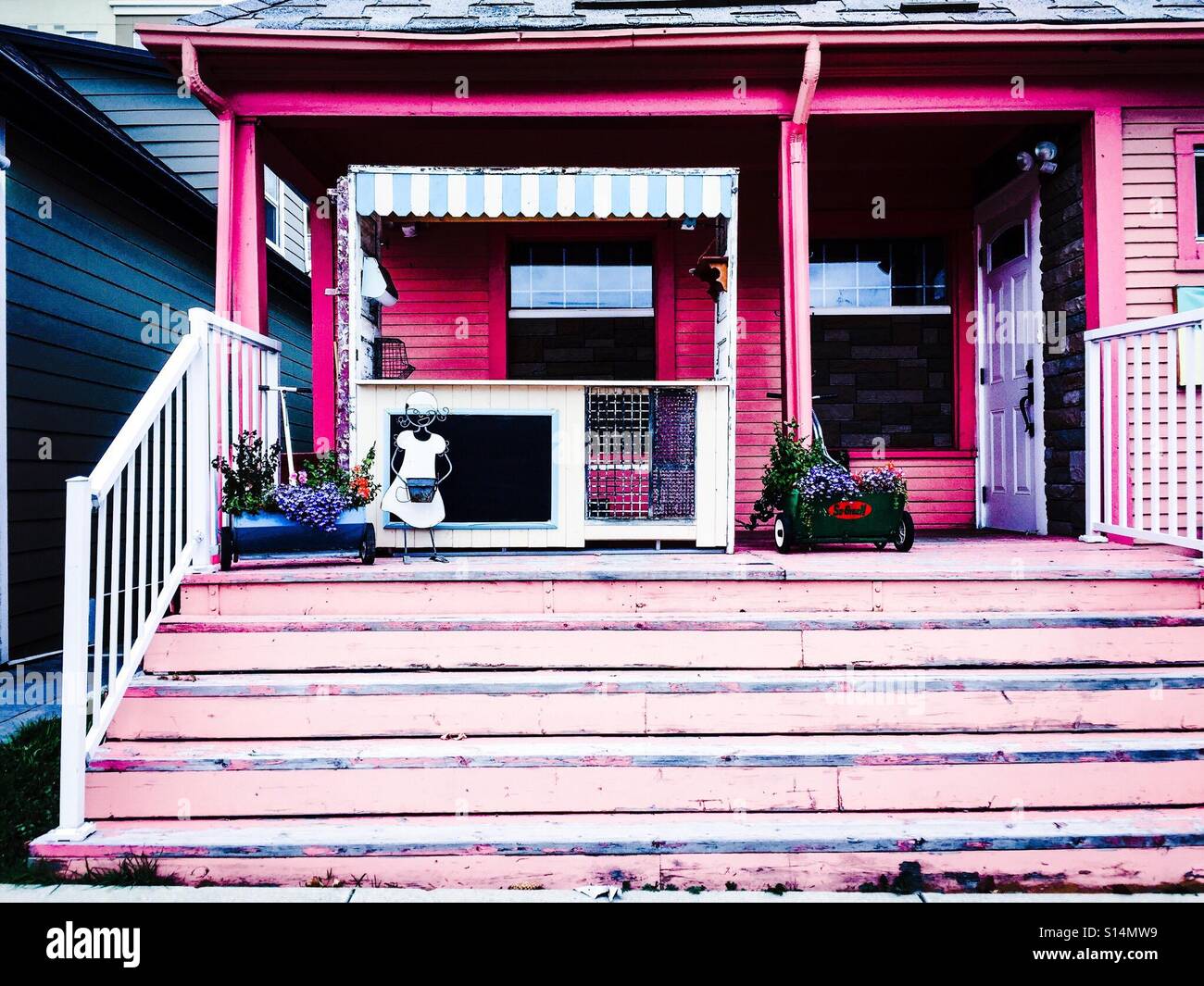 A lemonade stand is used as decoration on a home's front porch. - Smartphone Captured Stock Image