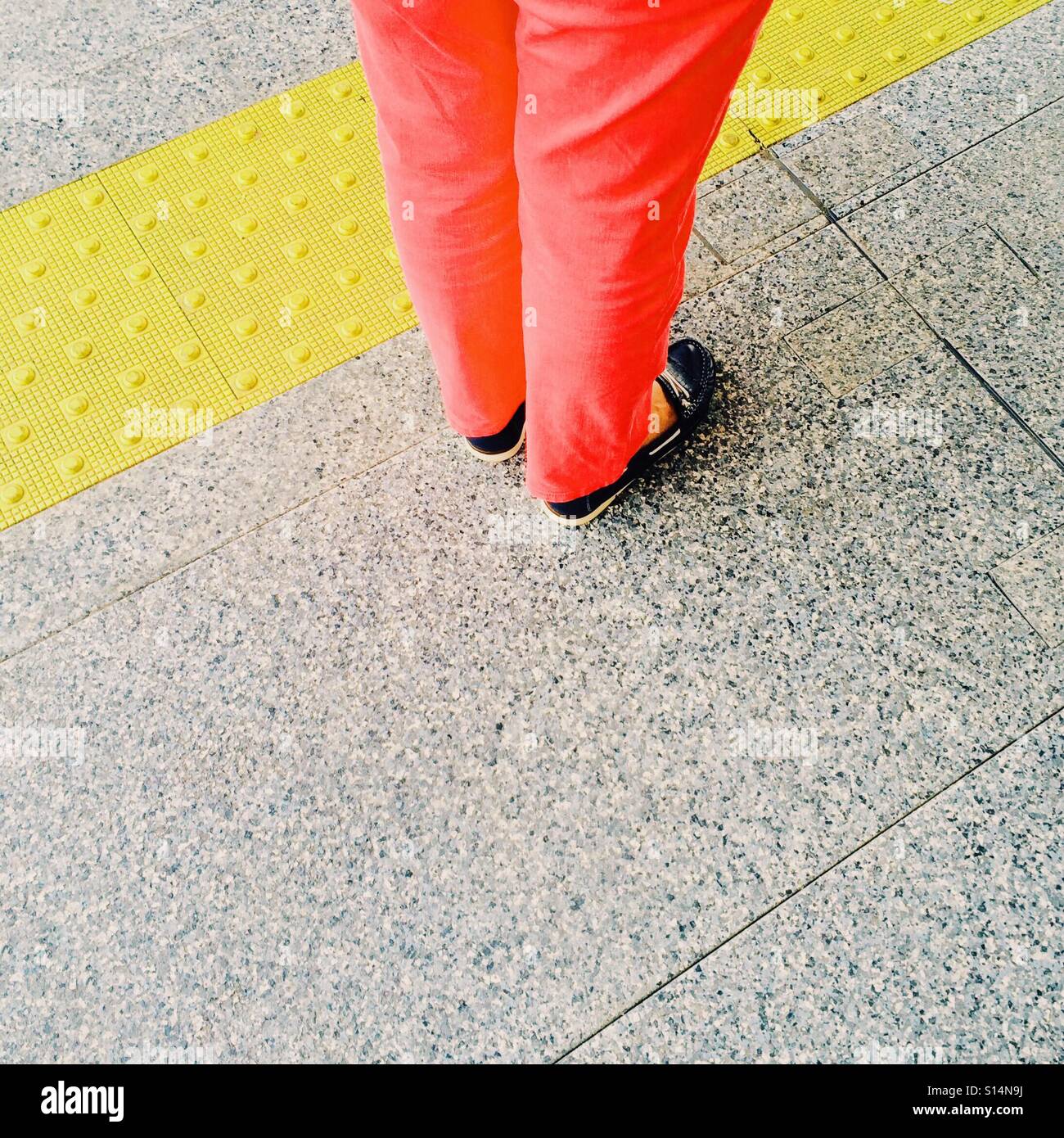 Tactile and coloured paving on a station platform to aid the visually impaired Stock Photo