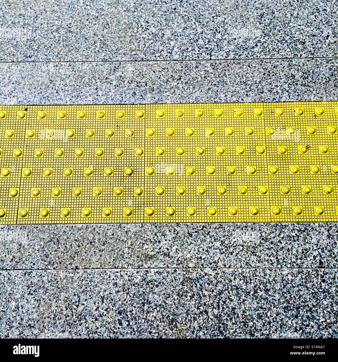 Tactile paving markings to warn the visibly impaired Stock Photo