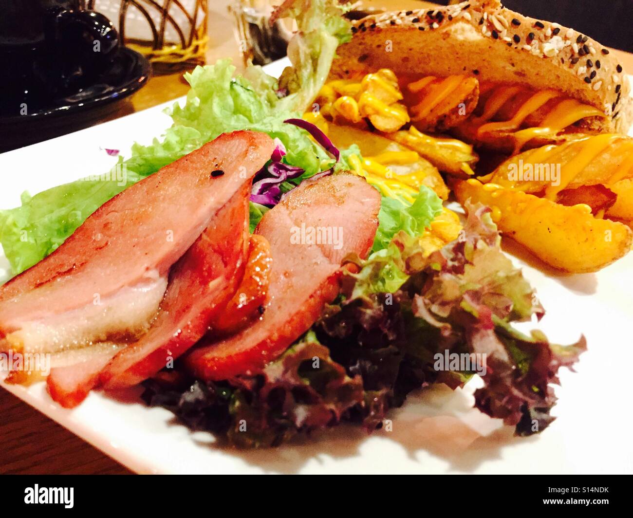 Sliced Duck meat with potato wedges Stock Photo