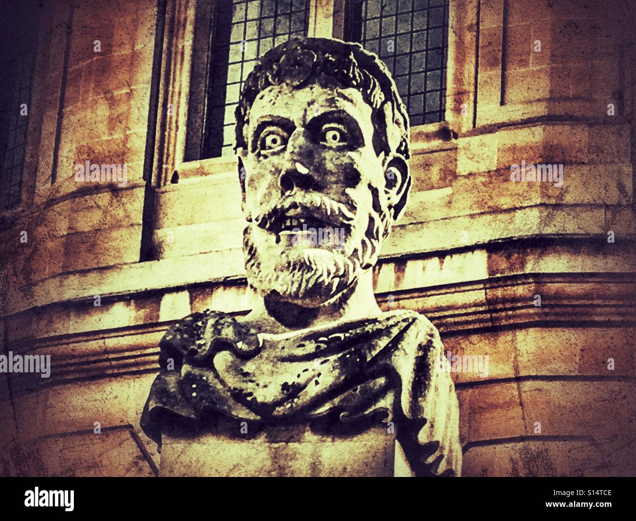Carved stone head on Broad Street, outside the ClarendonBuilding, University of Oxford, England - Smartphone Captured Stock Image