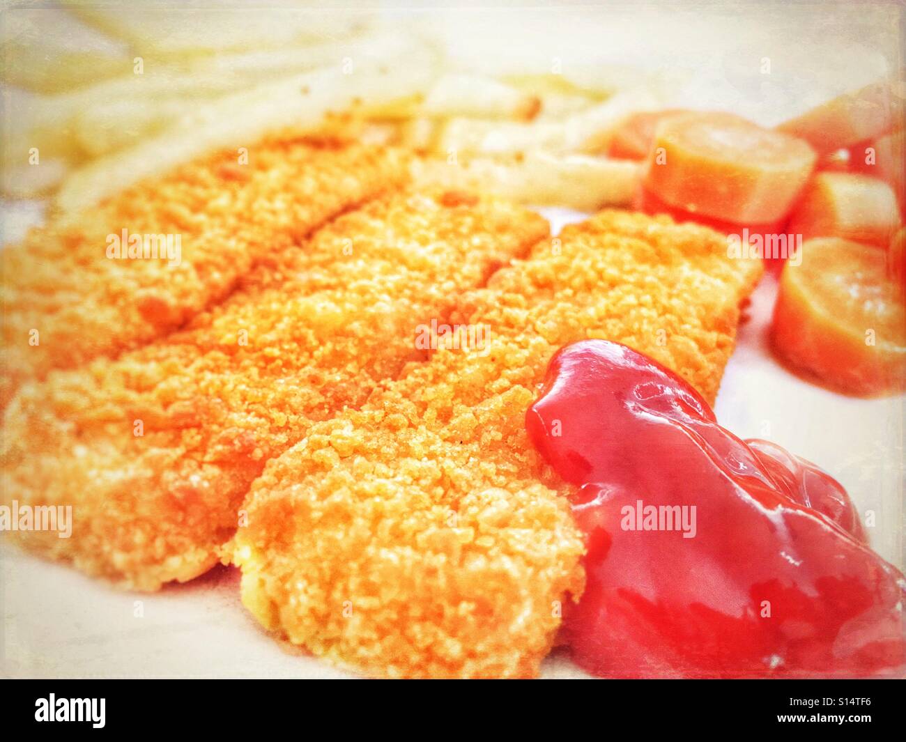 Fish fingers with tomato ketchup, carrots and chips - Smartphone Captured Stock Image