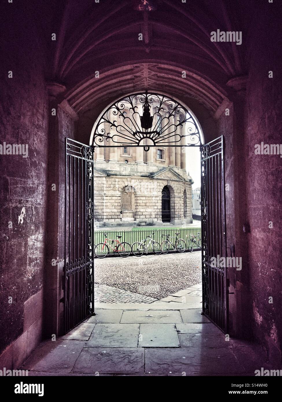 Vaulted passageway leading from the Bodleian Library out to Radcliffe Square with the Radcliffe Camera in view. University of Oxford, England - Smartphone Captured Stock Image