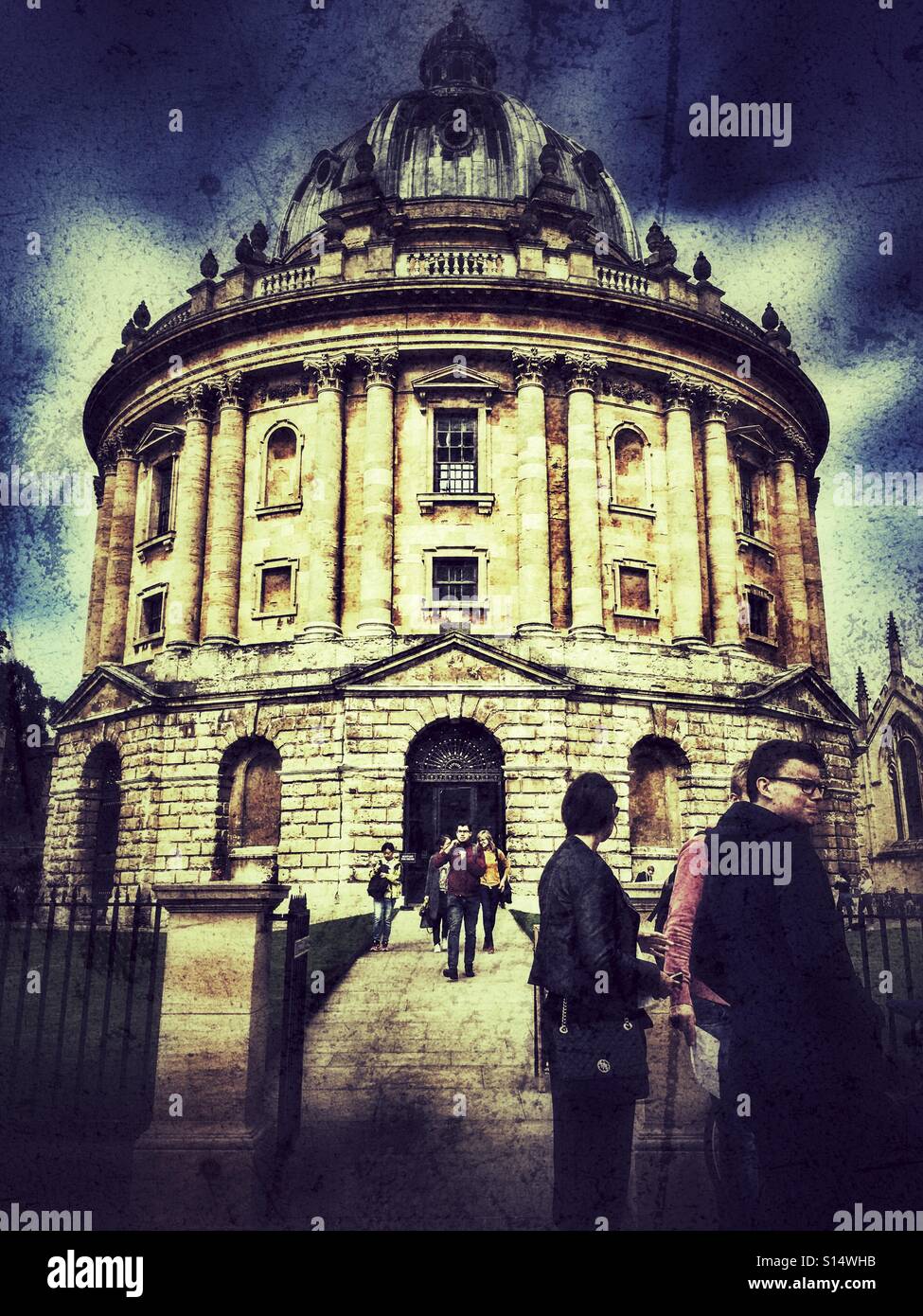 German tourists watching students coming out of the Radcliffe Camera, University of Oxford, England - Smartphone Captured Stock Image