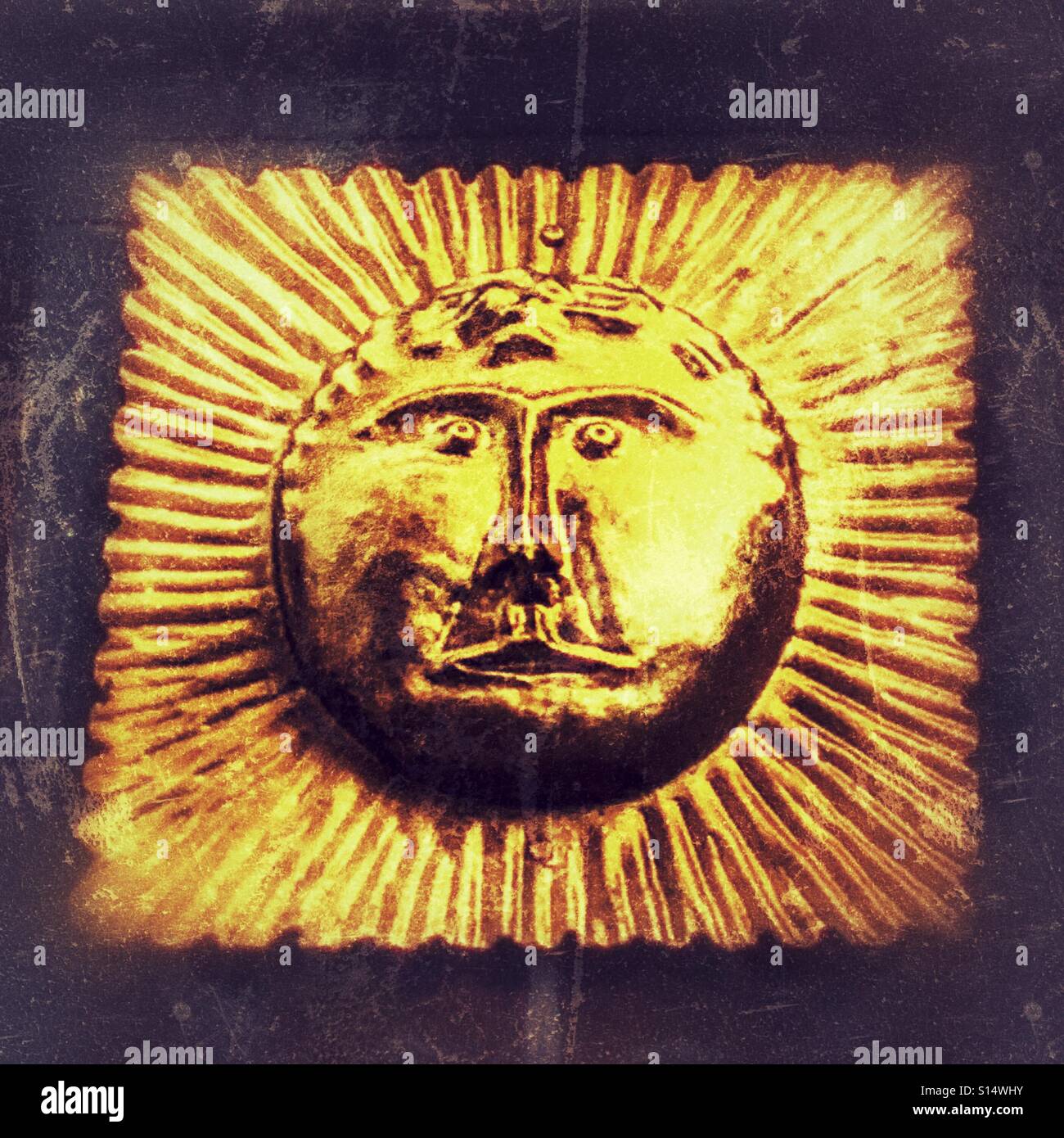 Golden face motif, surrounded by rays, decorating a wrought iron gate entrance to All Souls College, Oxford University, England - Smartphone Captured Stock Image