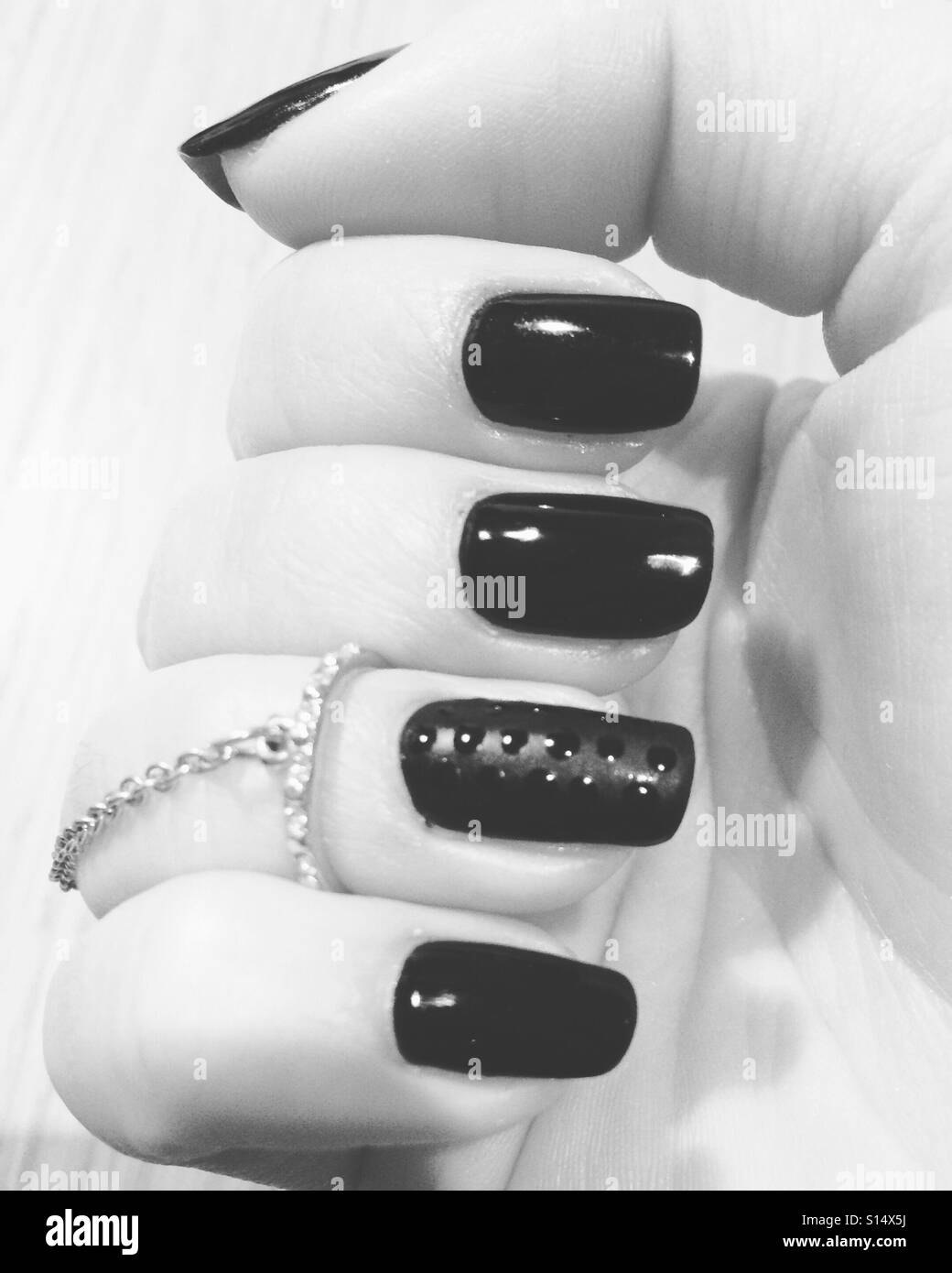 Black nails with matte black ring finger nail art Stock Photo - Alamy