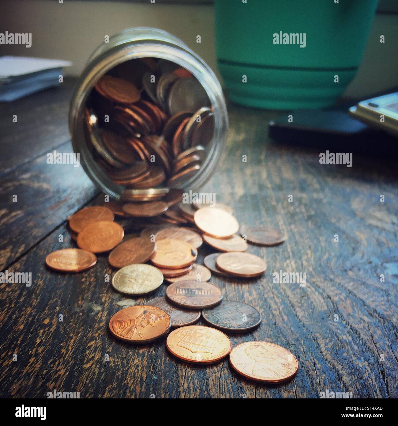 Tipped over change jar Stock Photo