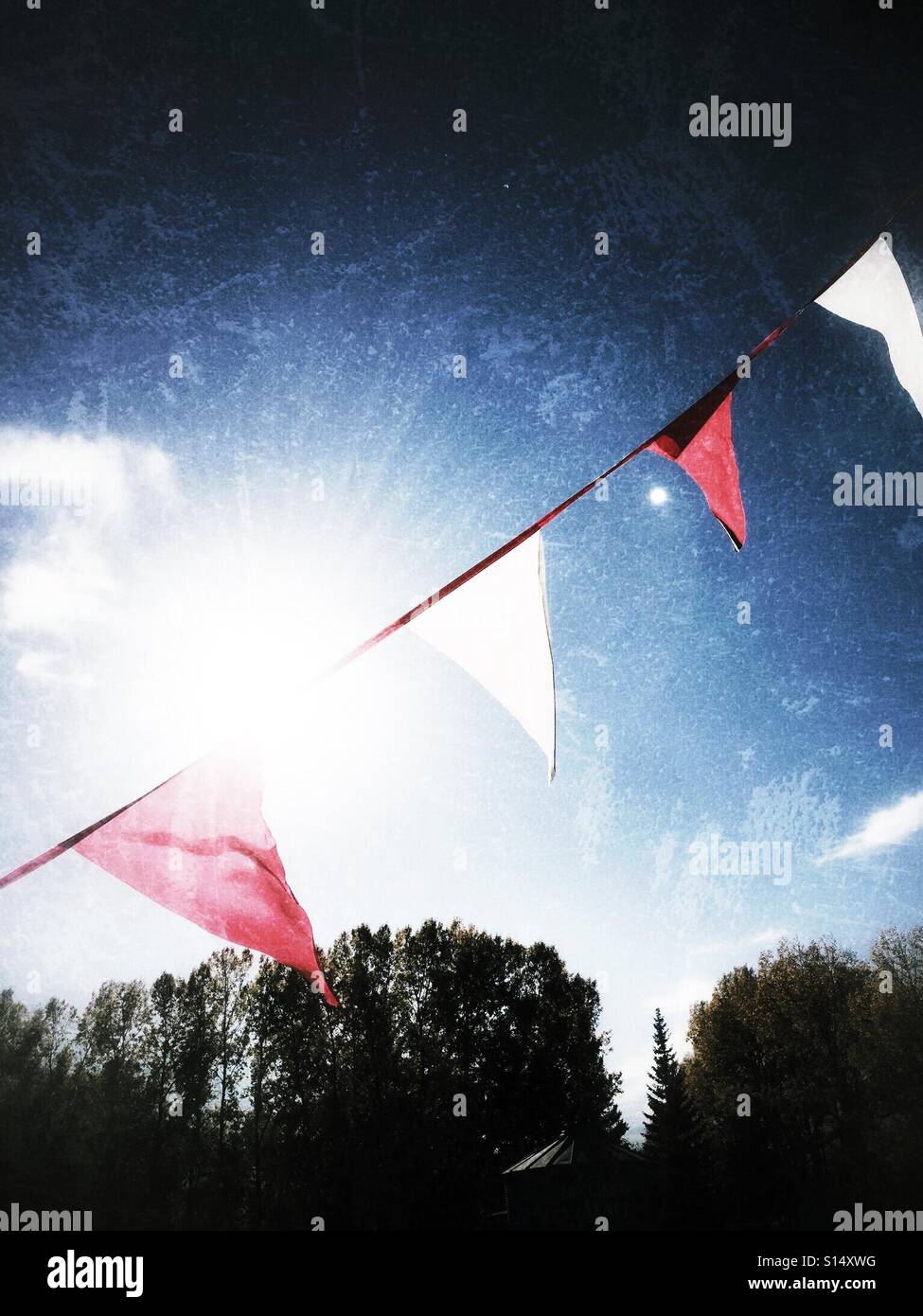 Backlit pennants blow in the wind. Stock Photo