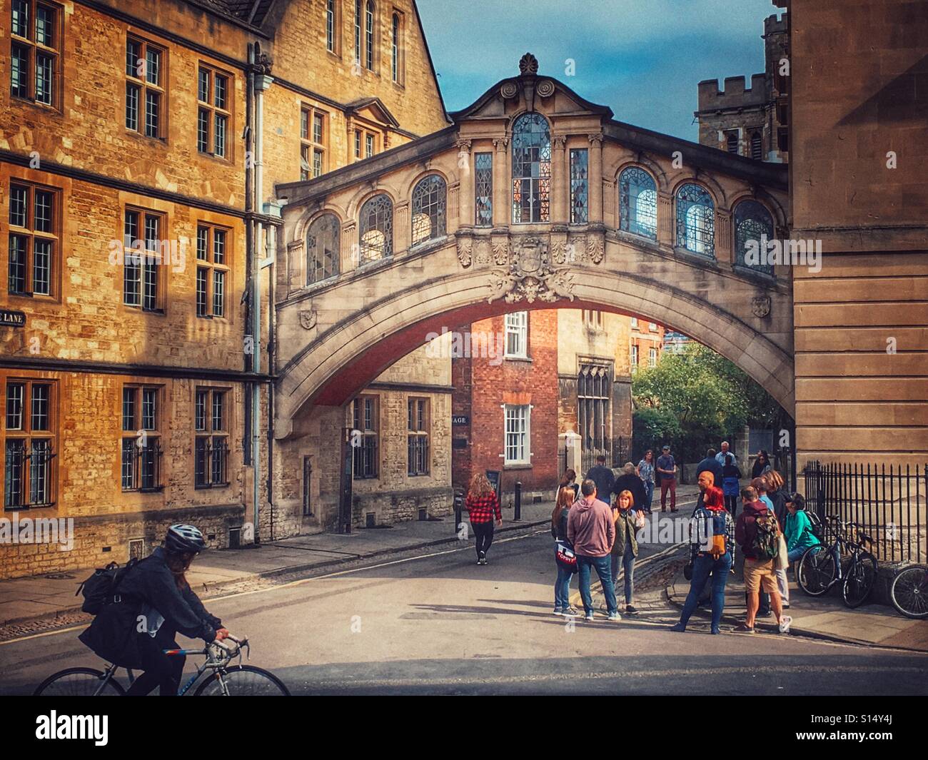 Cycling past Hertford Bridge, or the Bridge of Sighs, a skyway joining two parts of Hertford College over New College Lane. - Smartphone Captured Stock Image