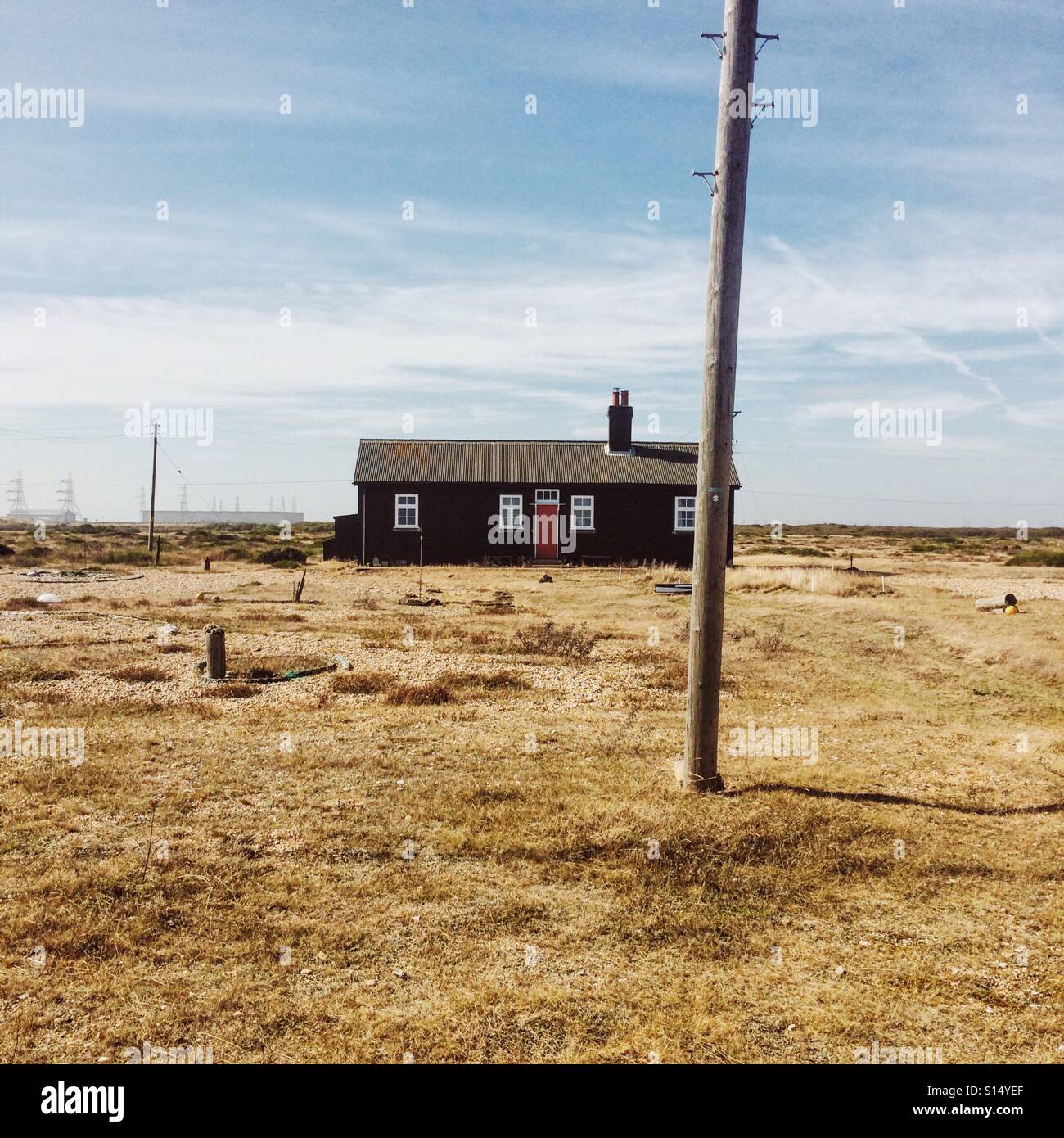 Lone house and telegraph pole in Dungeness Kent UK - Smartphone Captured Stock Image