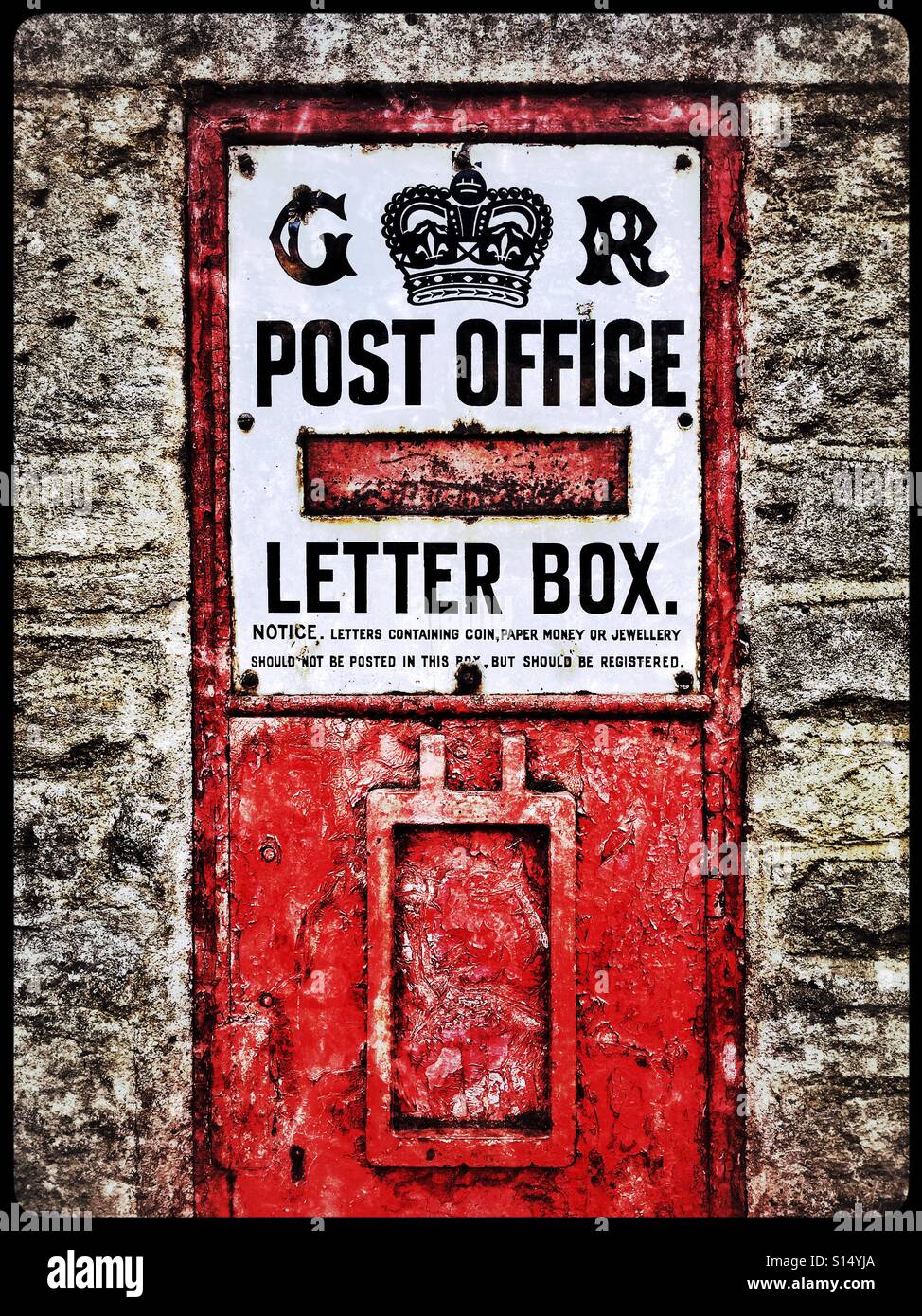 A high contrast image of an old post box in England, UK. The letters G & R next to the crown emblem identify the fact that this box was erected between 1910 & 1936 - during the reign of King George V. - Smartphone Captured Stock Image