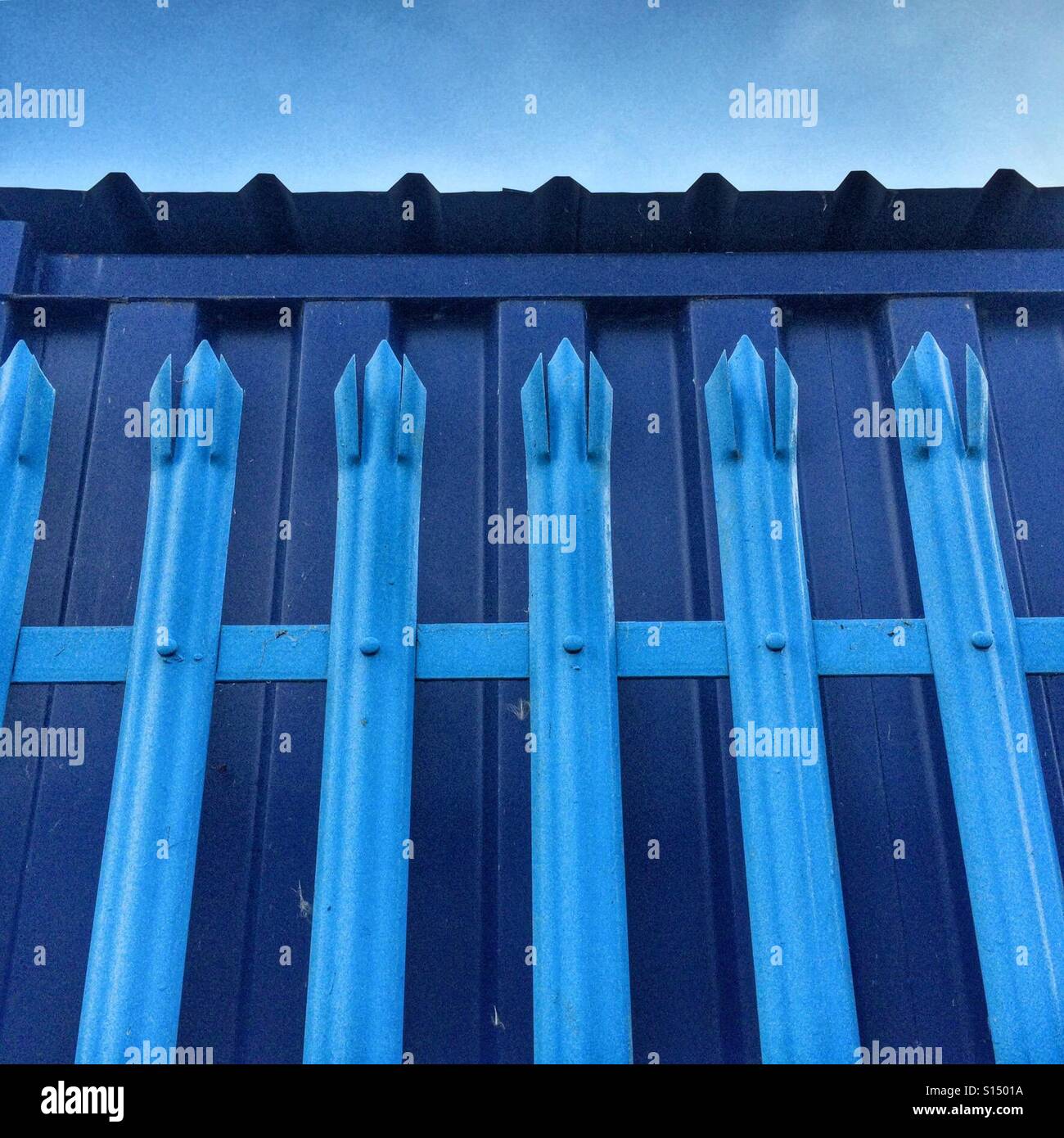 Blue security fence Stock Photo - Alamy