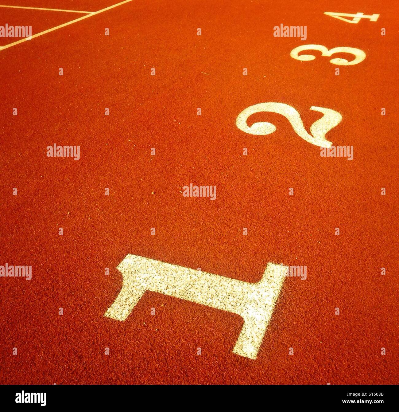 Number 1, 2, 3 and 4 on an athletic field track - Smartphone Captured Stock Image
