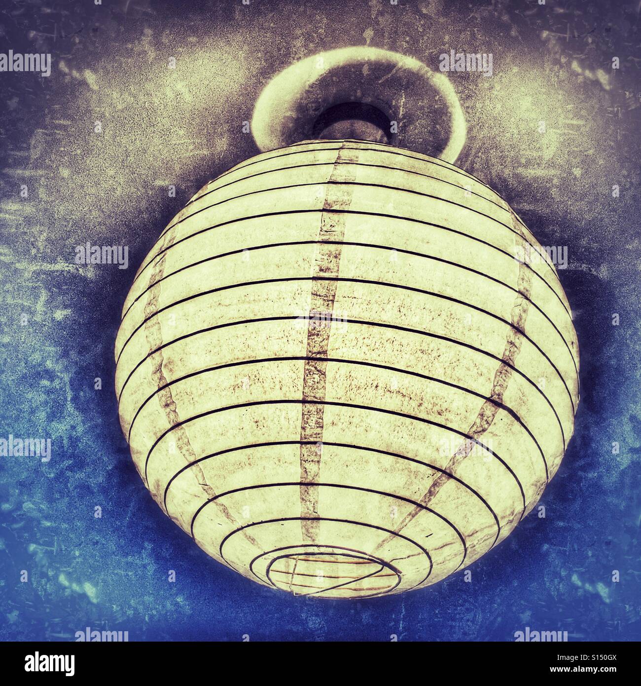 White paper lampshade on a wire frame. Ceiling light, on at night - Smartphone Captured Stock Image