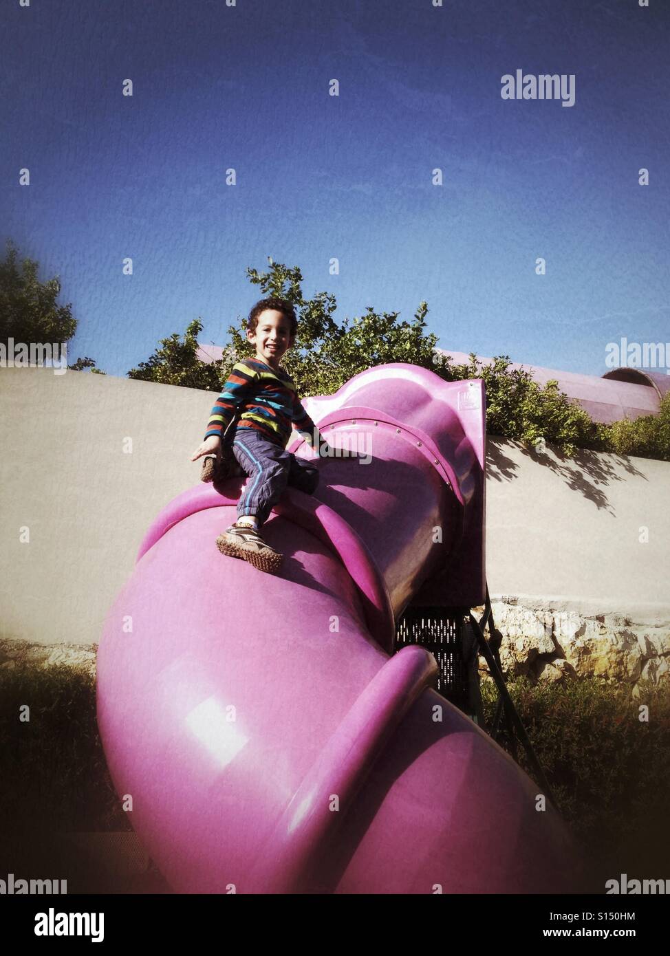 Active kid climes on top of the closed glide - Smartphone Captured Stock Image