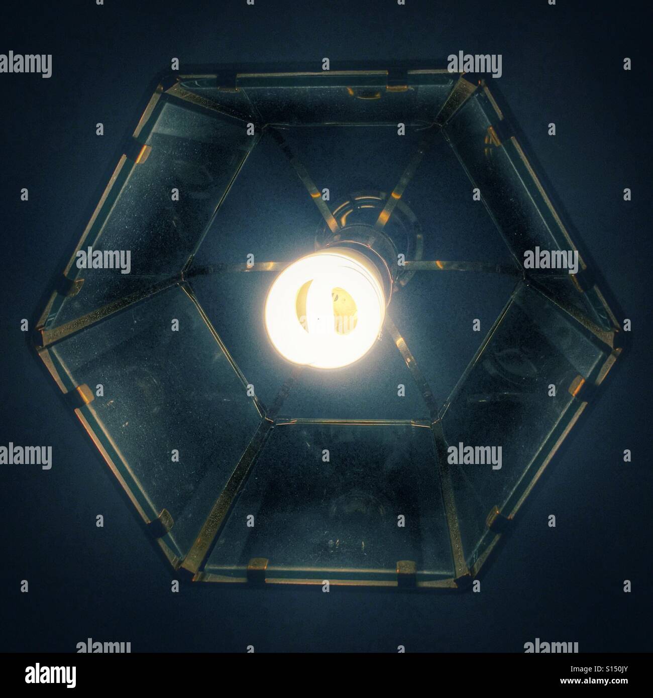 Abstract. Ceilings no light with a hexagonal glass shade, from below - Smartphone Captured Stock Image