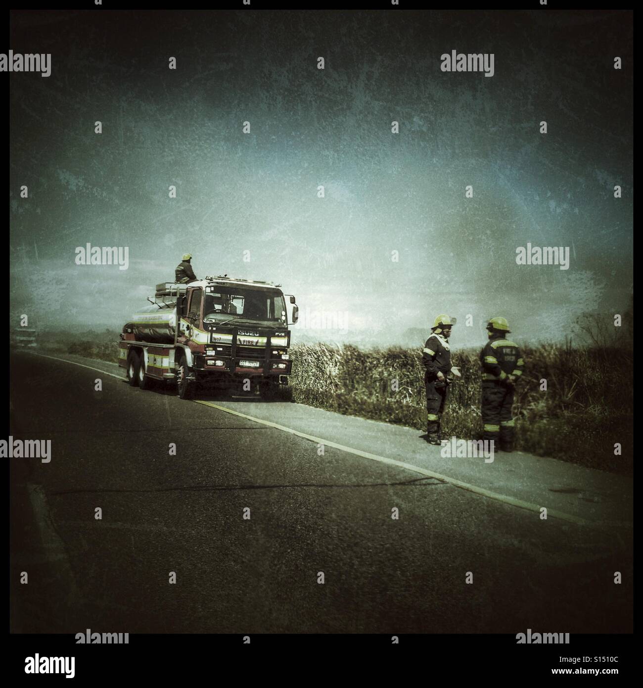 Firefighters on highway, heavy use of filters. - Smartphone Captured Stock Image