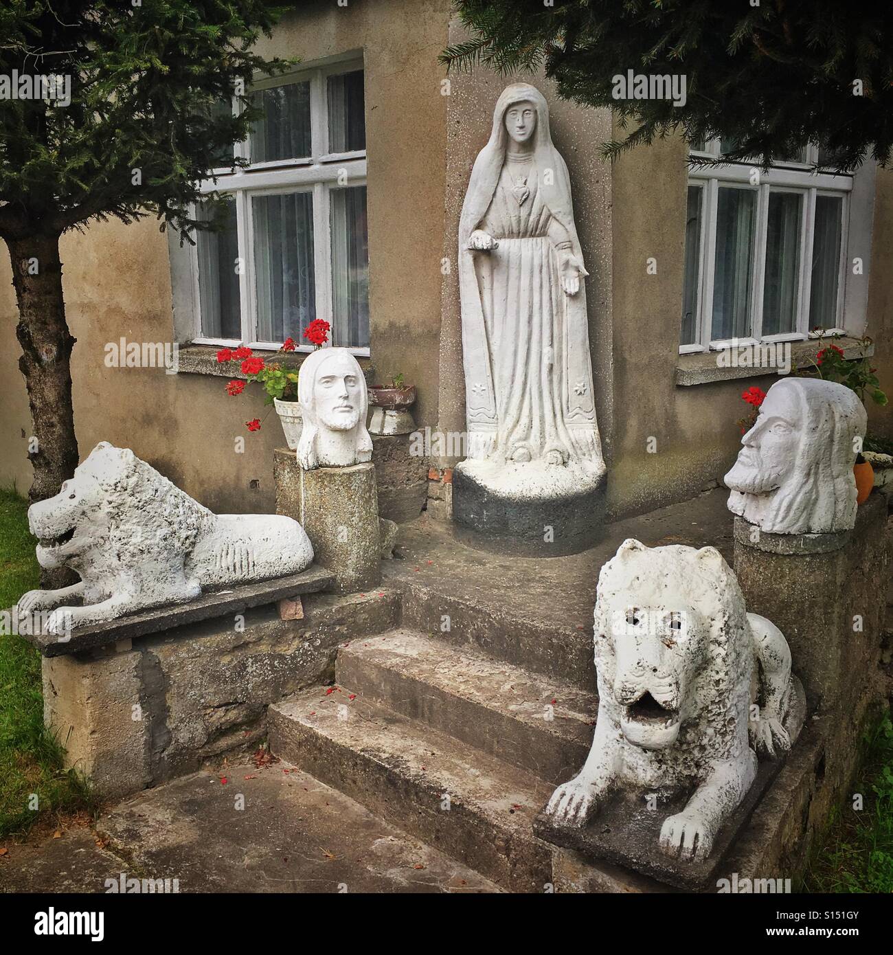Statues in front of house in Lesno village, Pomeranian Voivodeship, Poland Stock Photo