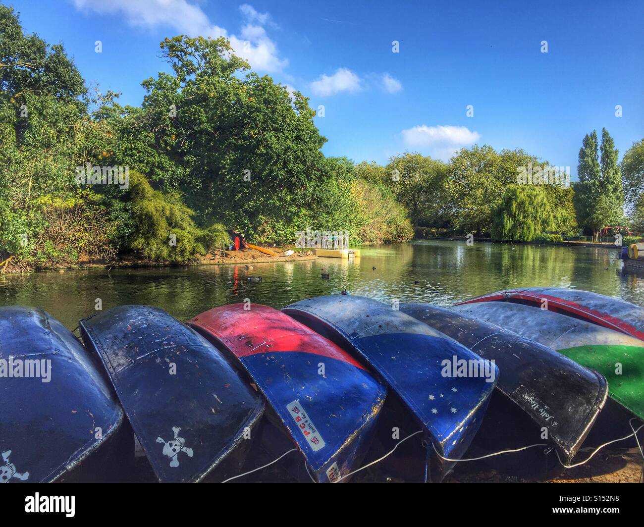 Upturned boats in a row by the lake in Finsbury Park, North London, UK - Smartphone Captured Stock Image