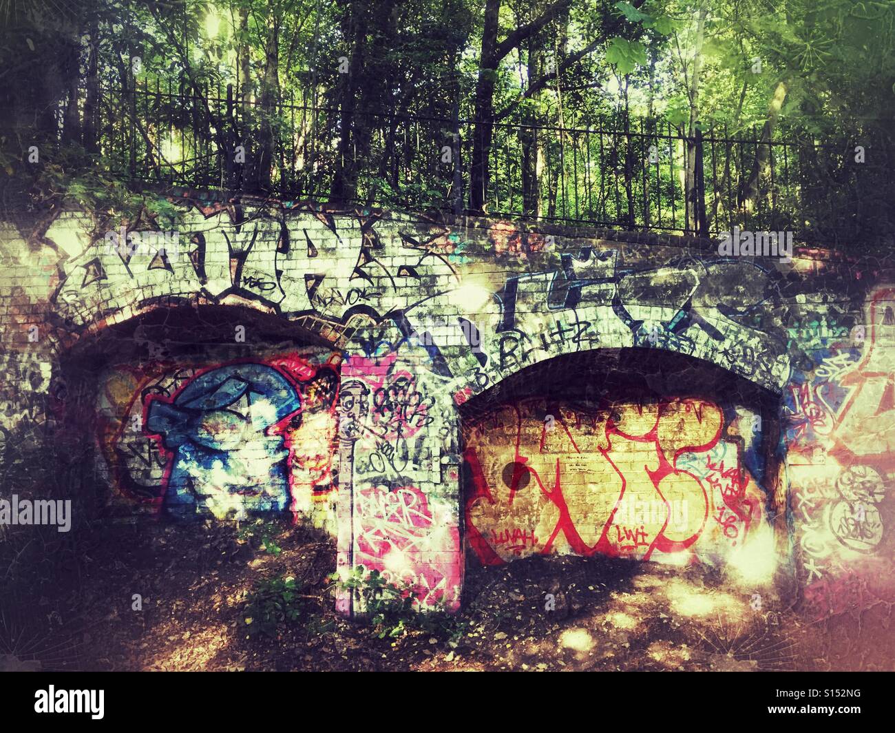 Graffiti on brickwork of disused railway, Parkland walk, Crouch Hill, Finsbury Park, Hornsey, Harringey, North London, UK - Smartphone Captured Stock Image