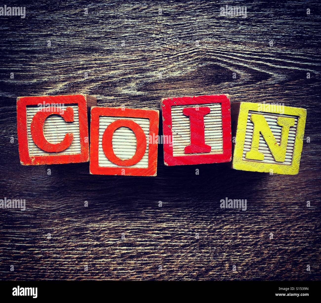 COIN word written with alphabet wood block letter toys - Smartphone Captured Stock Image