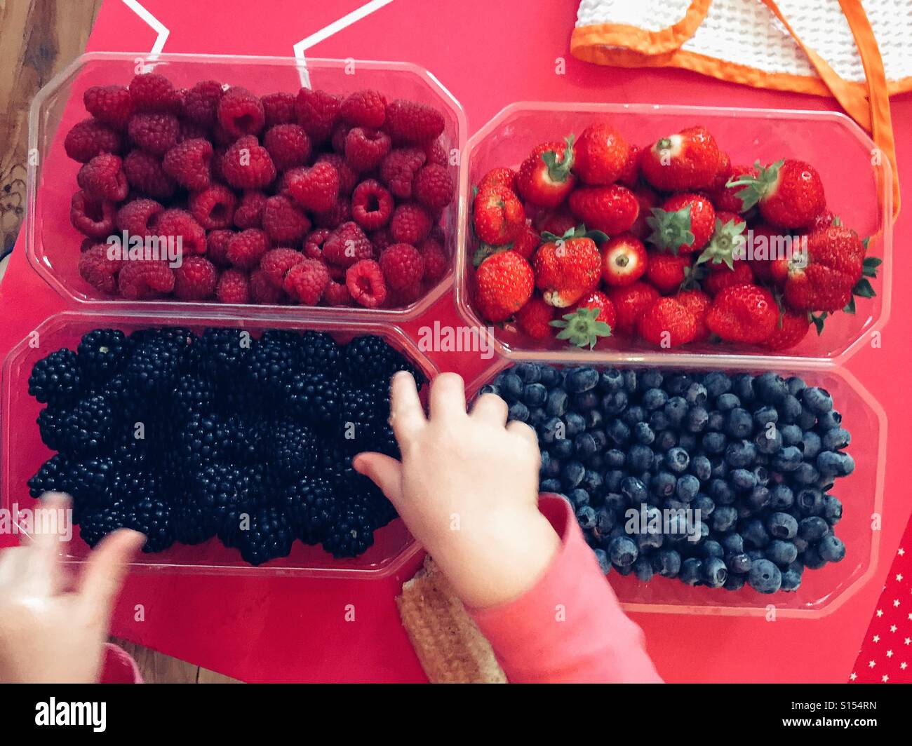 Toddler eating fruits Stock Photo Alamy