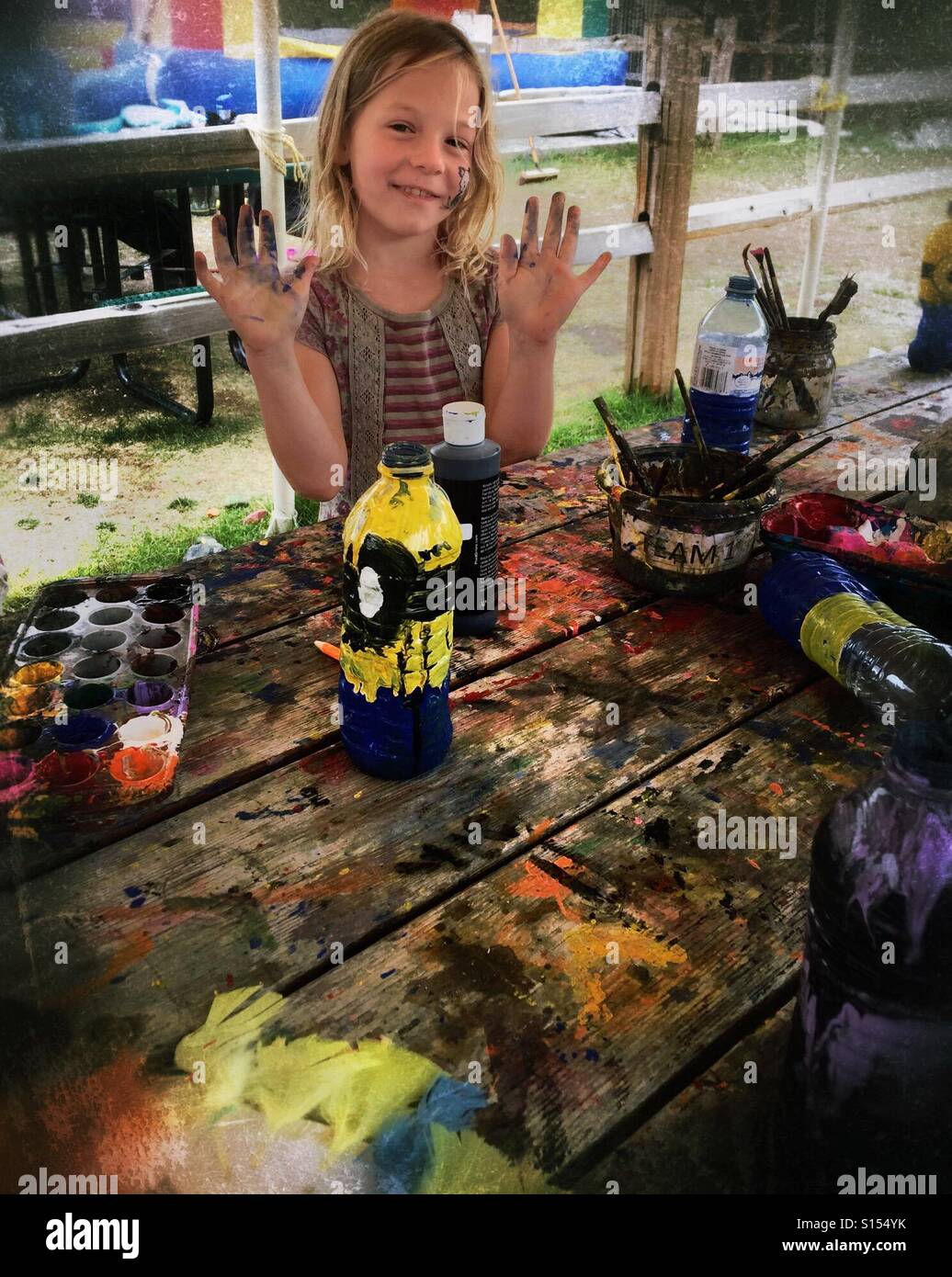 A girl gets messy at a craft fair. - Smartphone Captured Stock Image