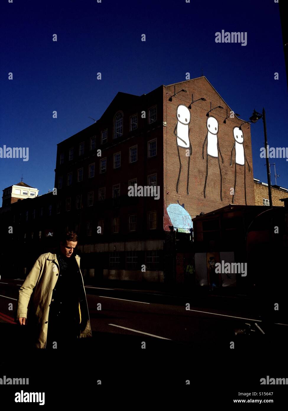 Mural artist Stik's latest mural on the side of a building in shoreditch London - Smartphone Captured Stock Image