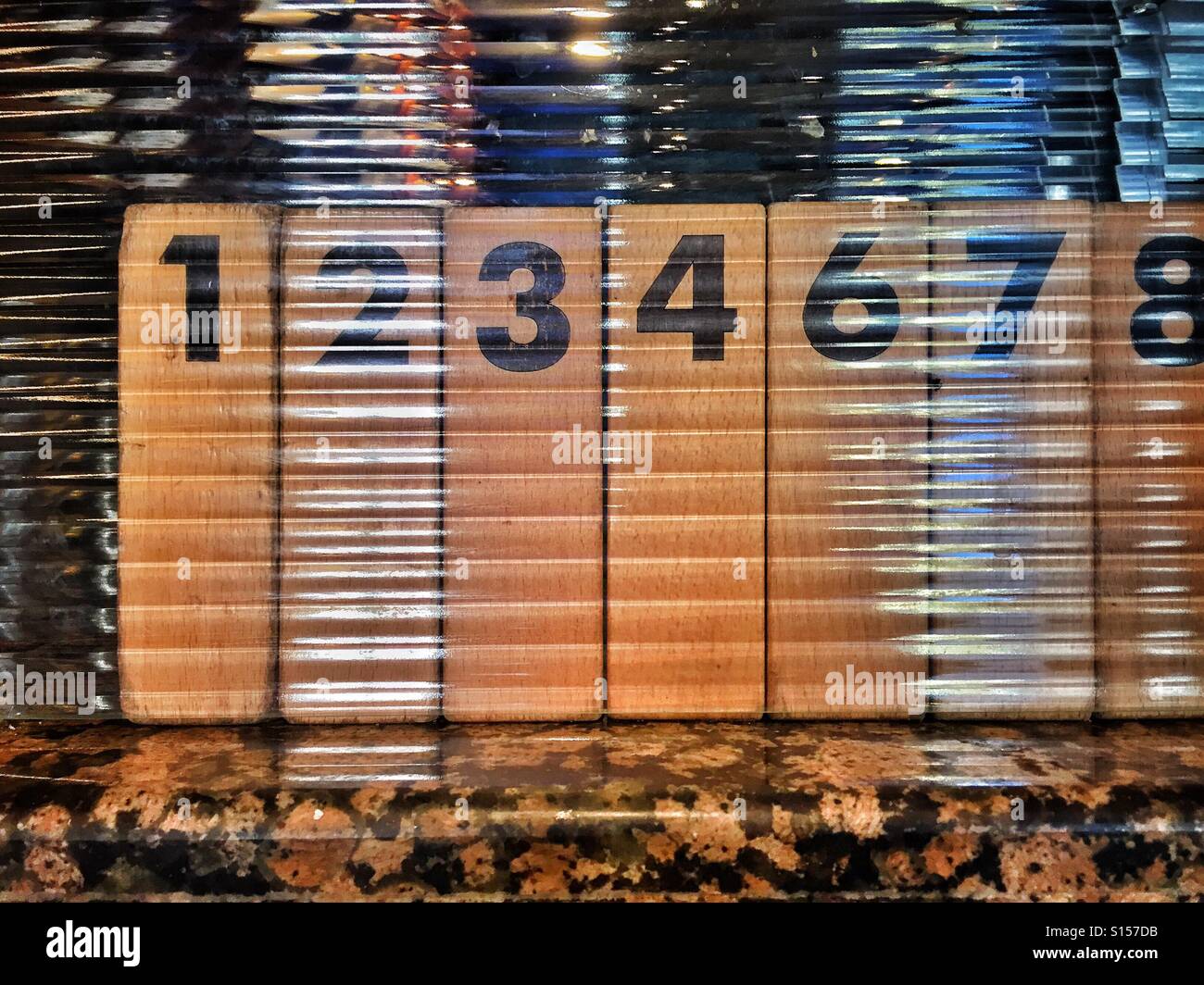 What happened to Number 5?! A row of single digit numbers written on blocks of wood. Photo Credit - © COLIN HOSKINS. - Smartphone Captured Stock Image