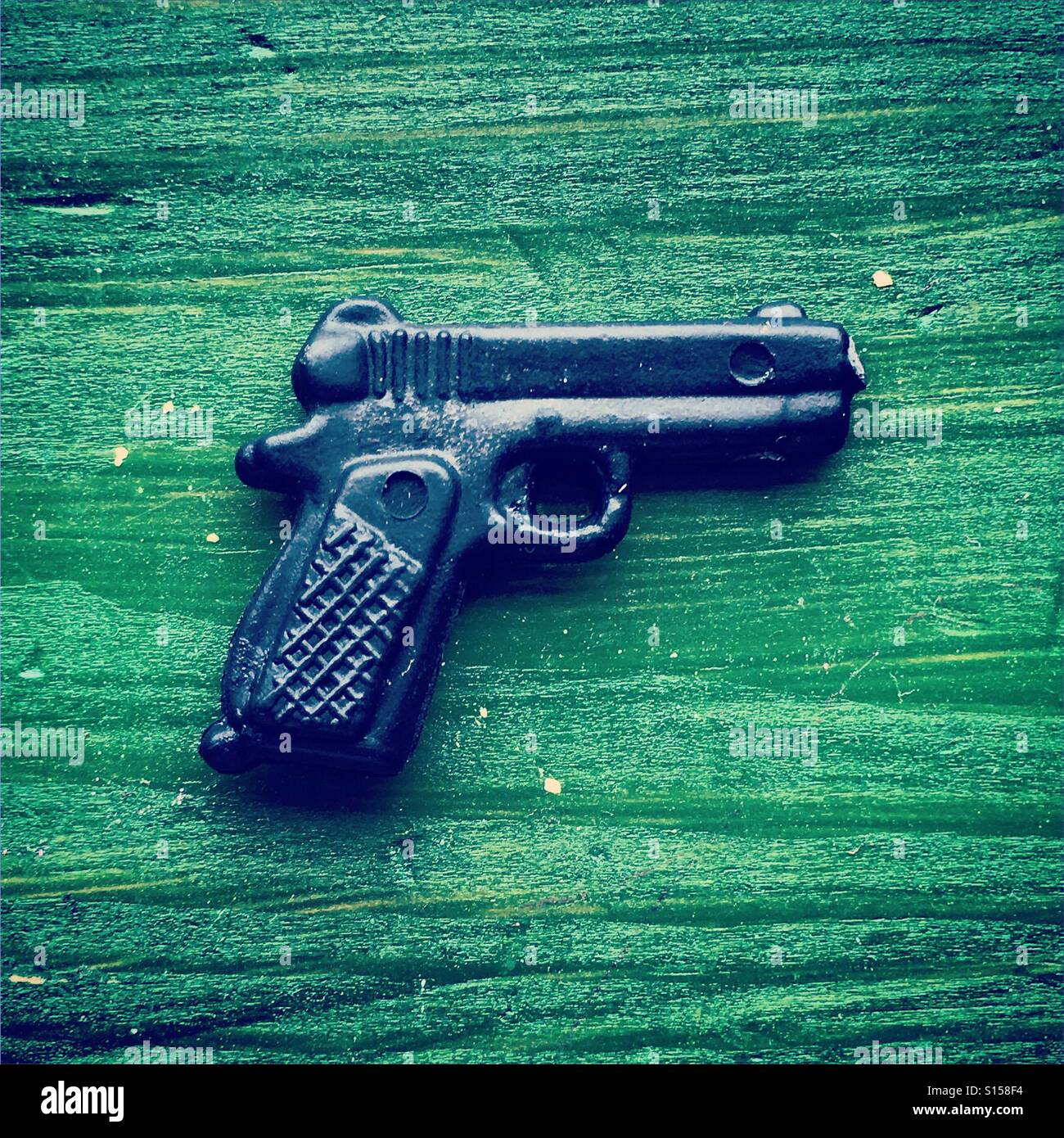 Plastic gun on green - Smartphone Captured Stock Image