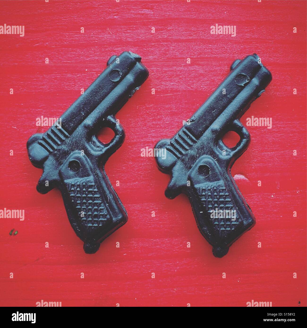 double gun on red background - Smartphone Captured Stock Image
