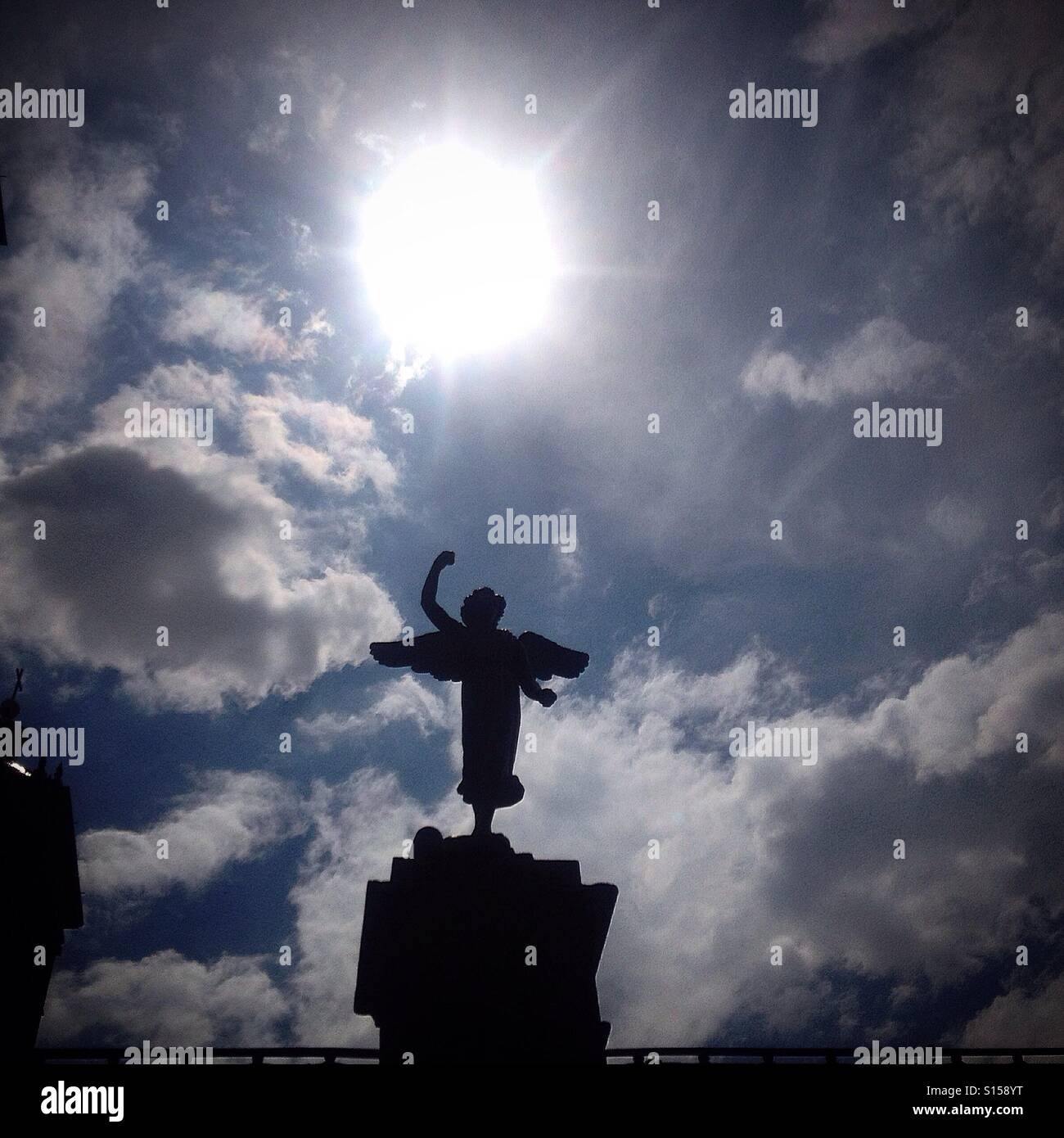 The Sun shines over a sculpture of an angel in the Cathedral of Puebla de Zaragoza in Mexico City, Mexico - Smartphone Captured Stock Image