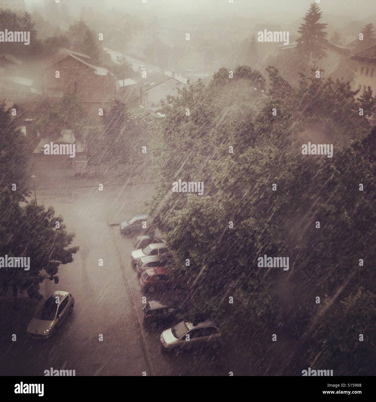 Rain shower over parking lot Stock Photo Alamy
