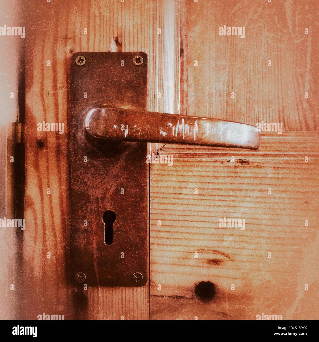Close up of metal handle on wooden door - Smartphone Captured Stock Image