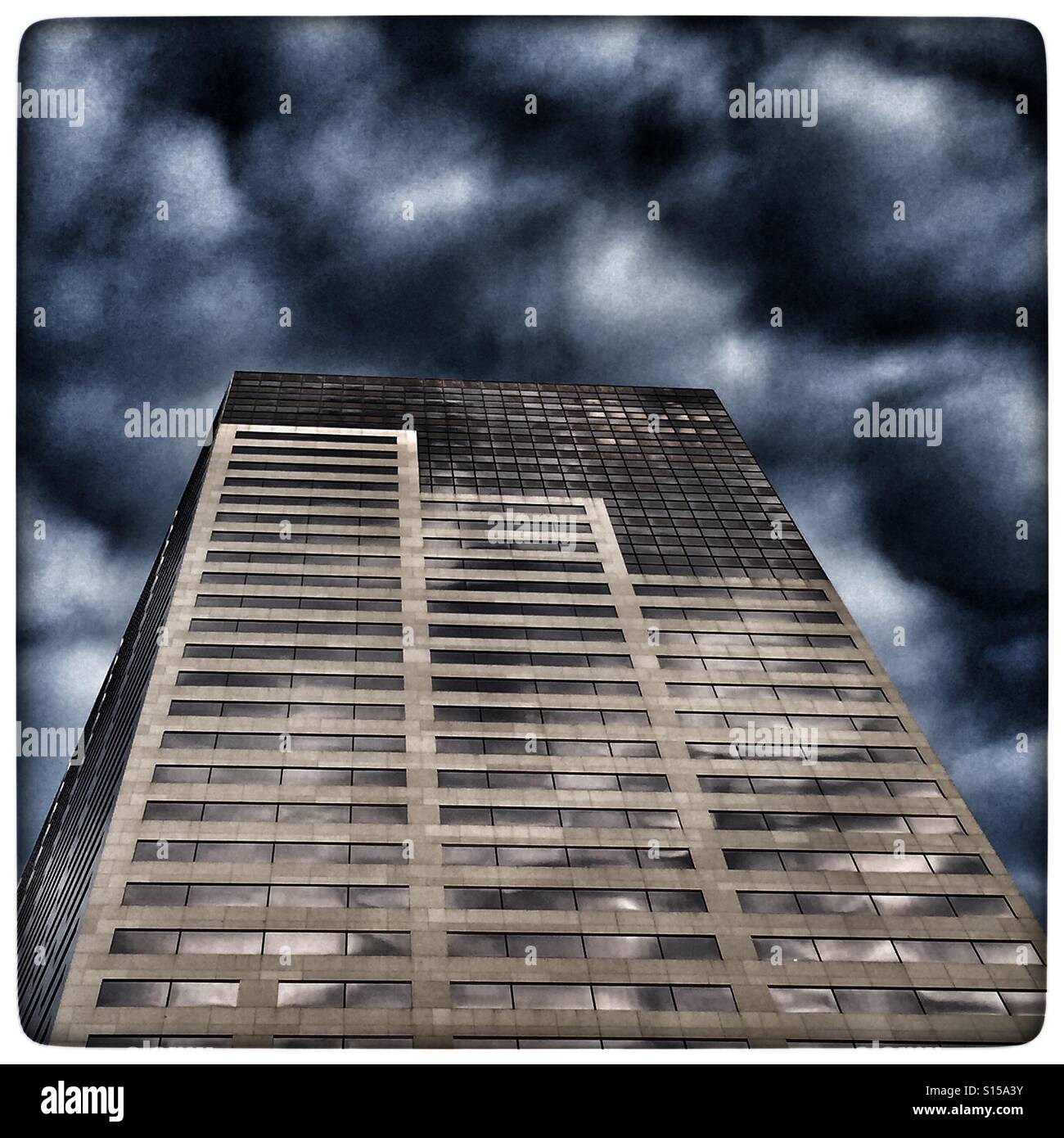 Storm clouds roll over tall building Portland Oregon Stock Photo