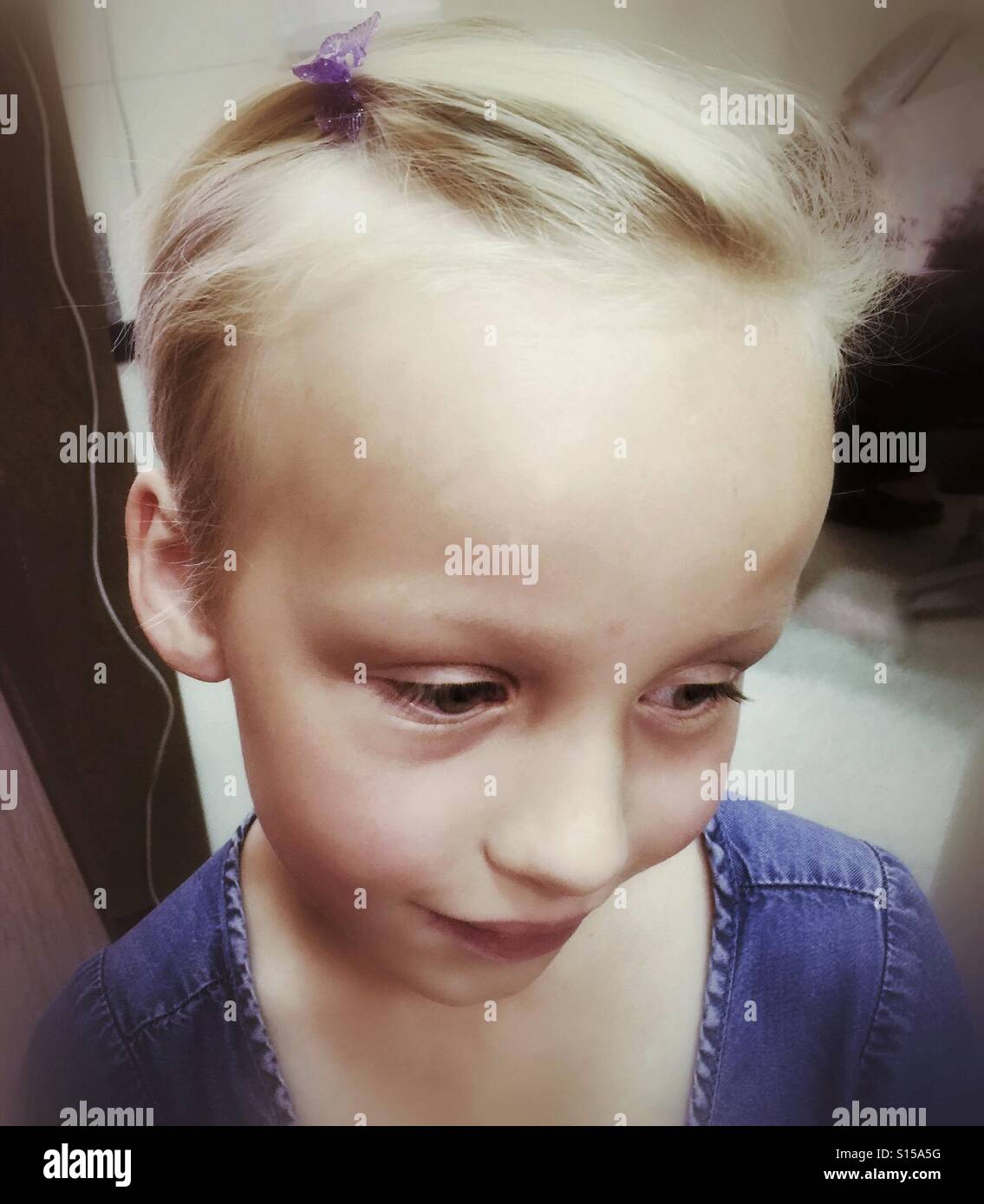 A shy girl with a clip in her hair. - Smartphone Captured Stock Image