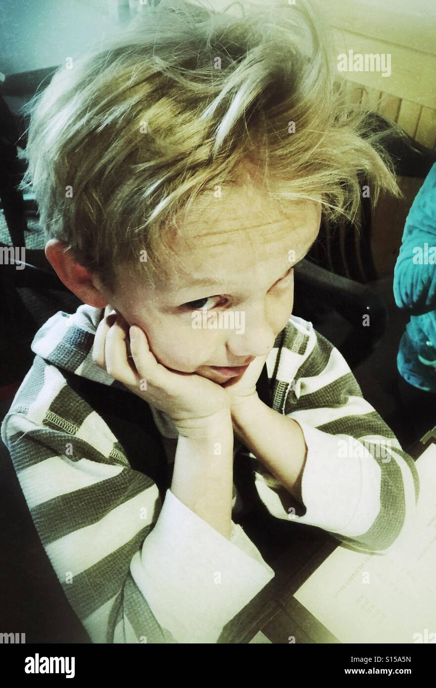 A boy with crazy hair looks up skeptically Stock Photo - Alamy