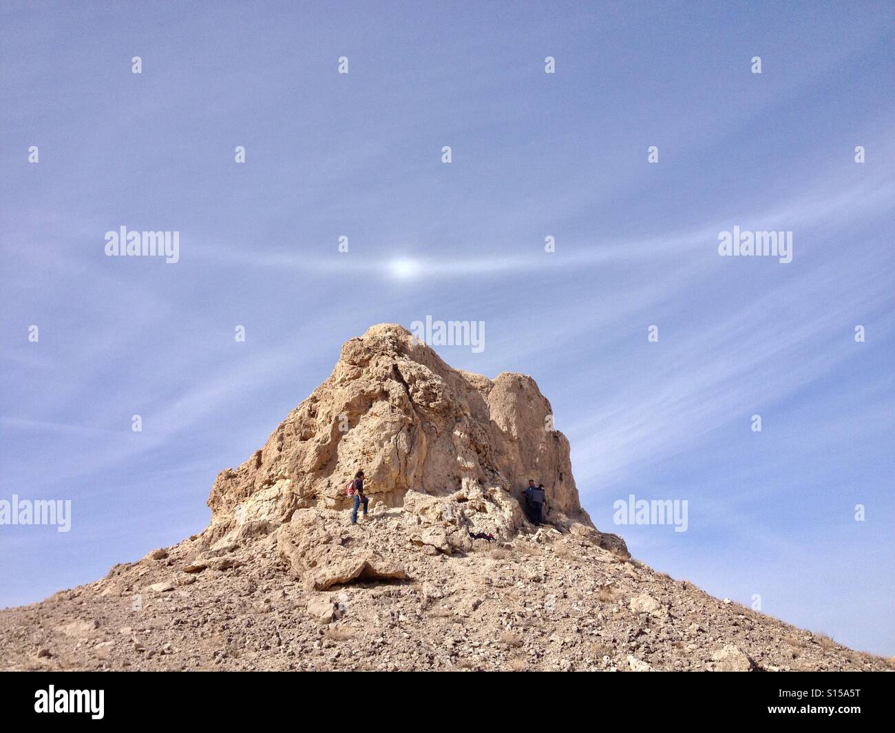 Woman hiking at Trona Pinnacles, California with natural halo effect in sky Stock Photo