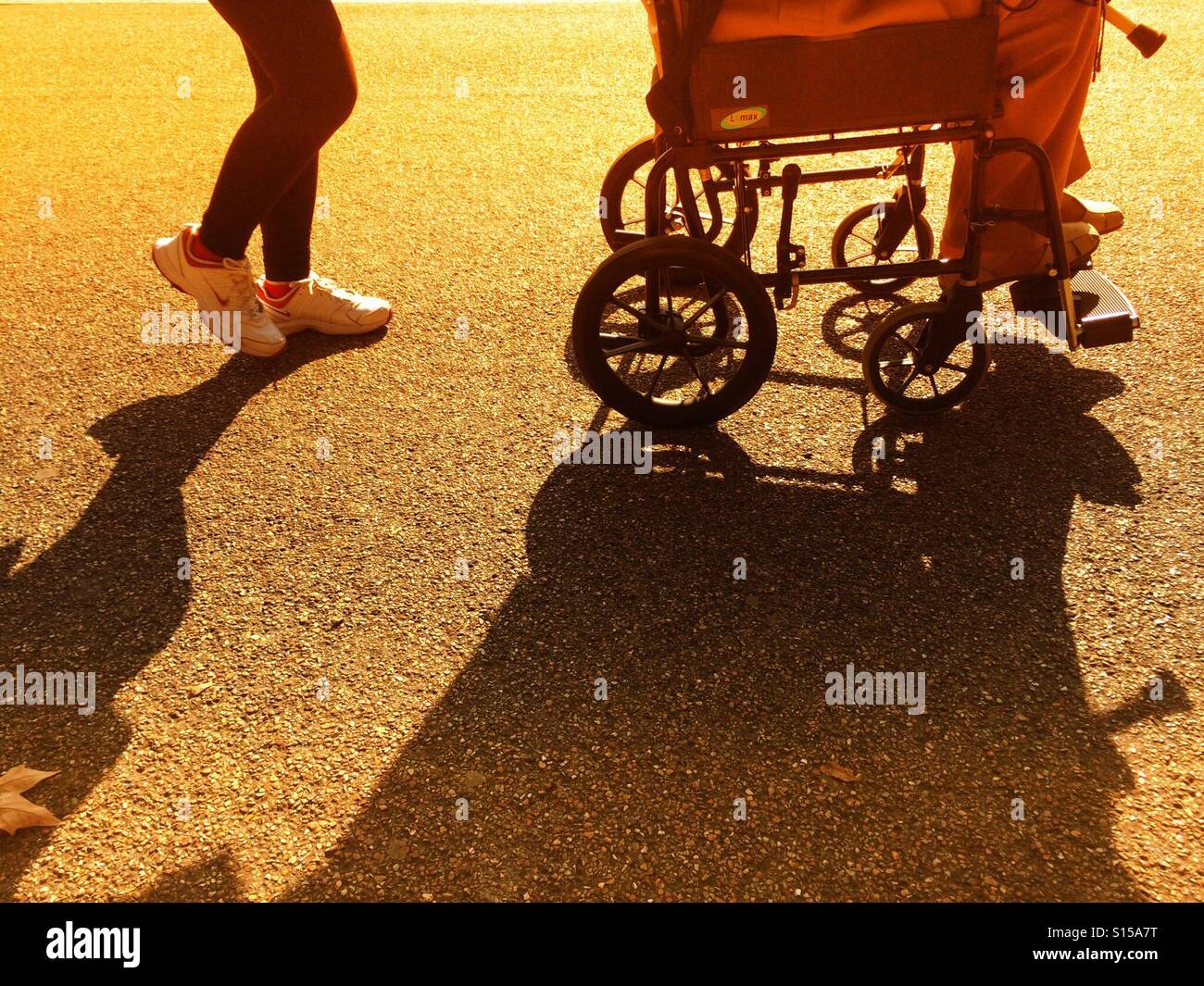 Wheelchair and person pushing - Smartphone Captured Stock Image