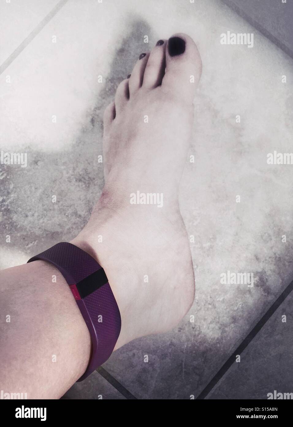 A Fitbit fitness tracker worn on an ankle Stock Photo - Alamy