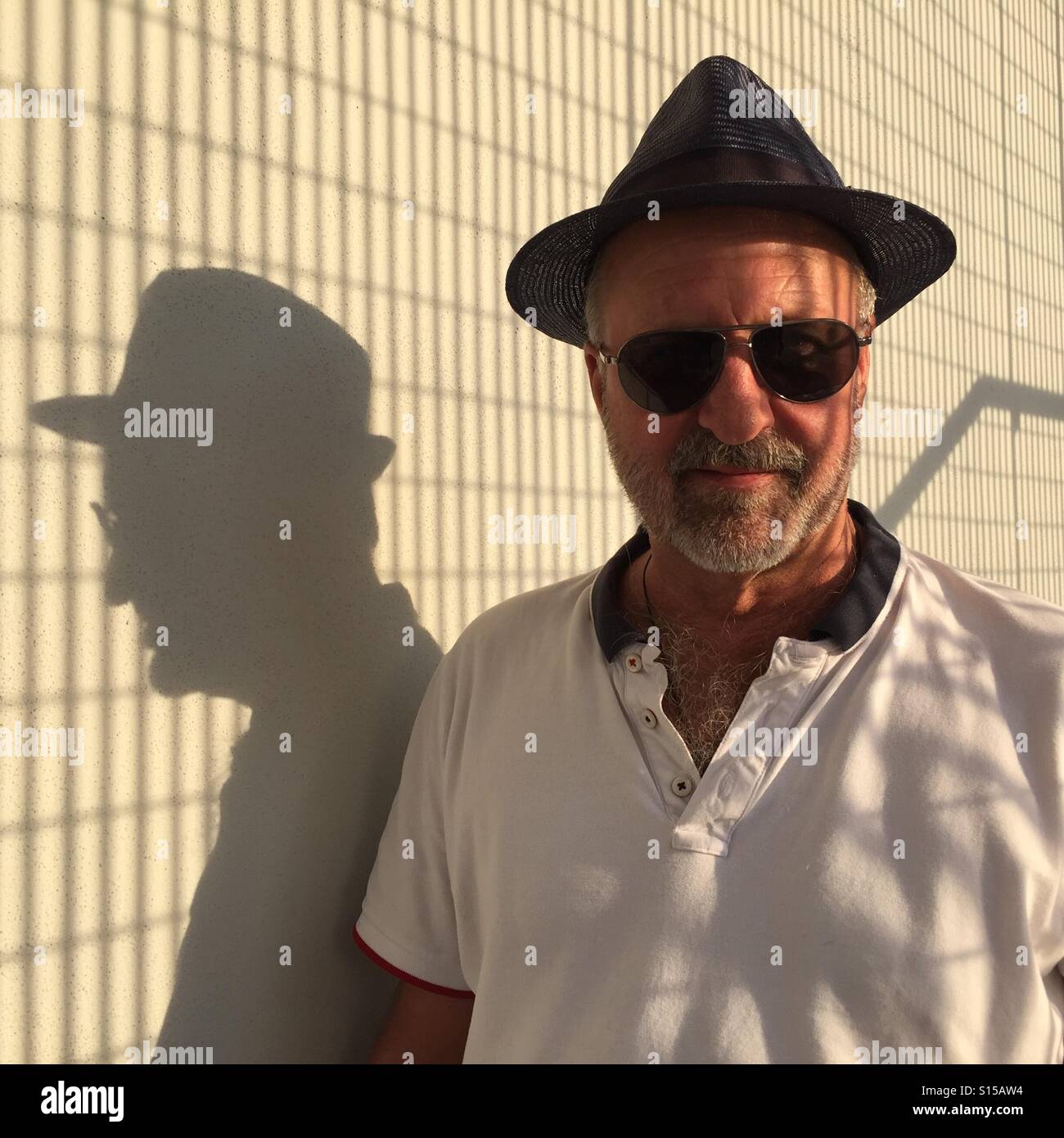 Bearded man in hat and sunglasses with reflections - Smartphone Captured Stock Image