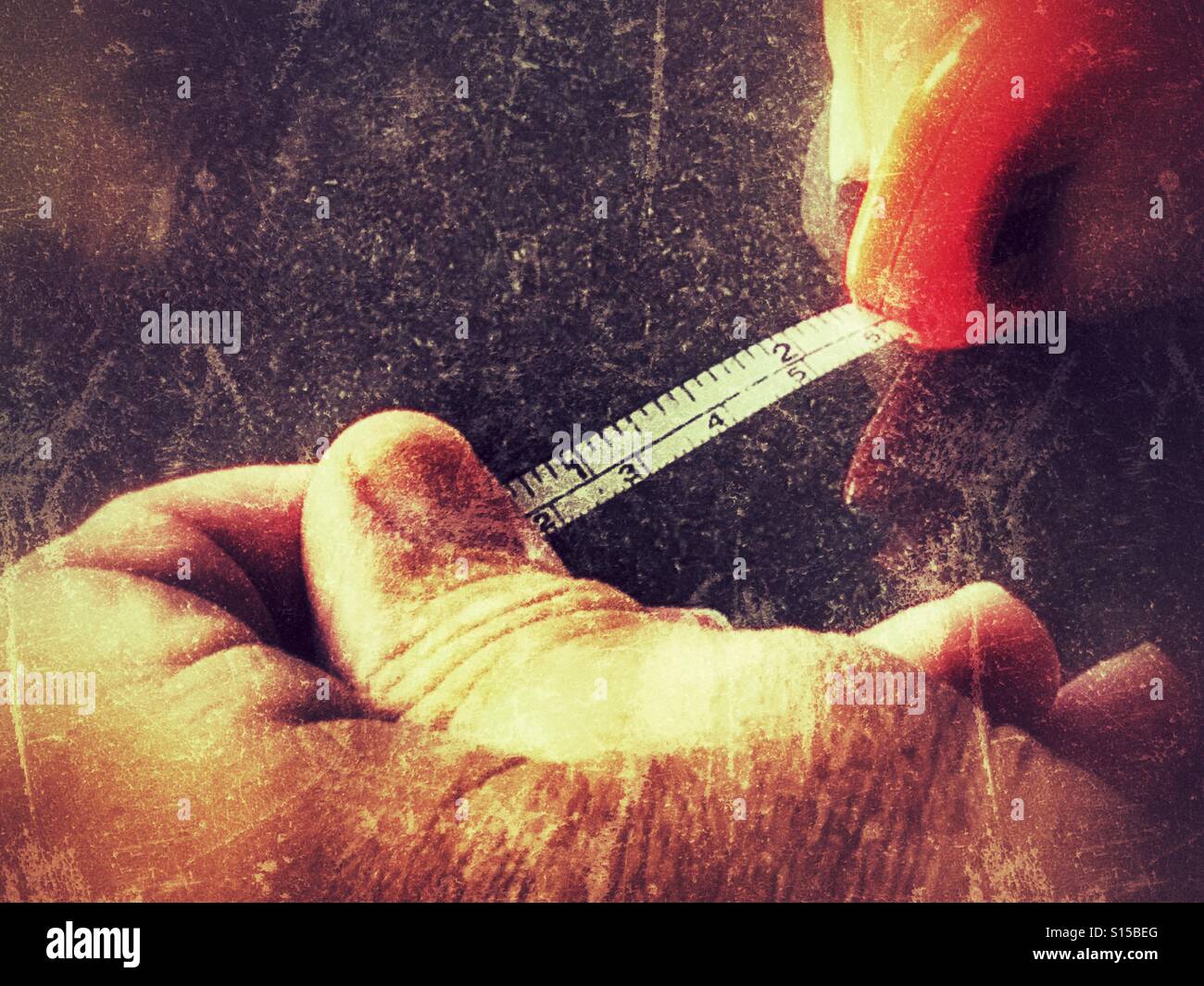 Man pulling tape measure, close up - Smartphone Captured Stock Image