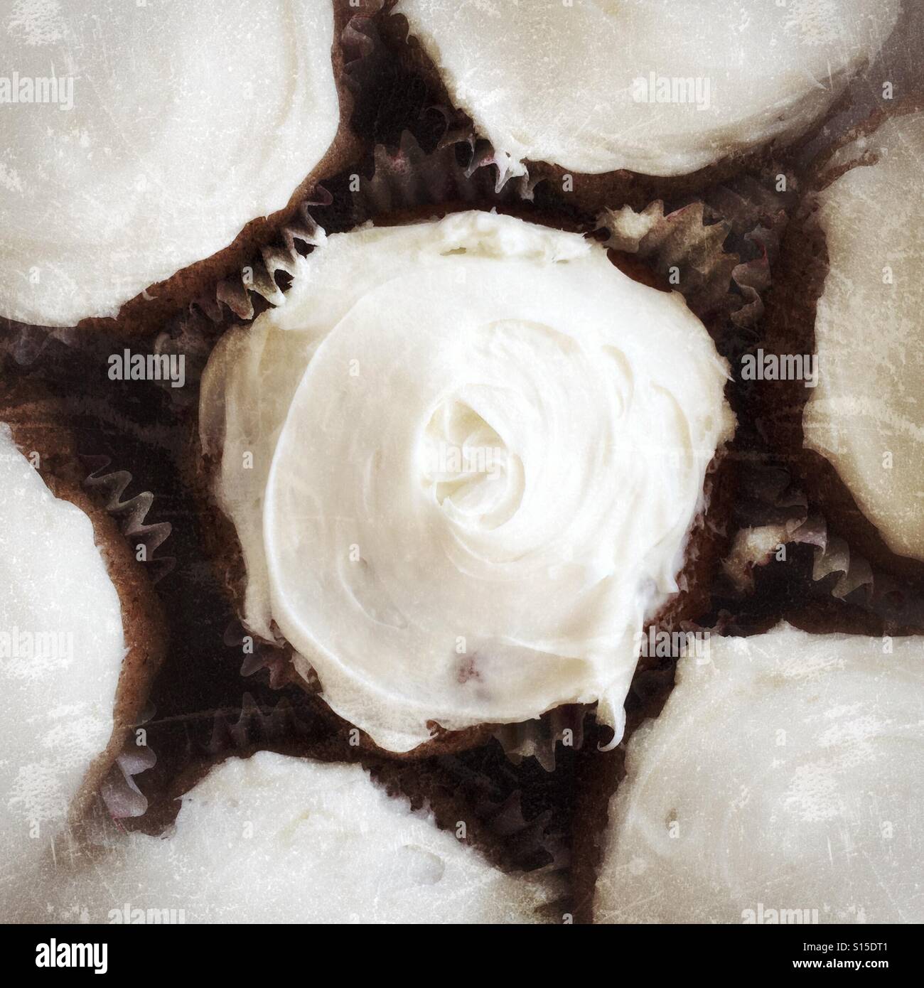 White frosting swirls on cupcakes. - Smartphone Captured Stock Image