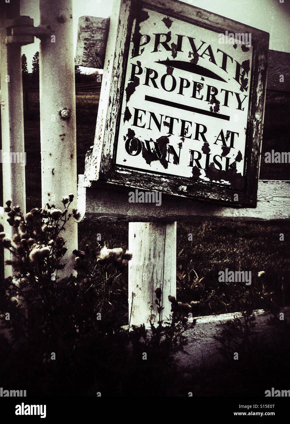 A private property sign hangs on a rural fence. Stock Photo