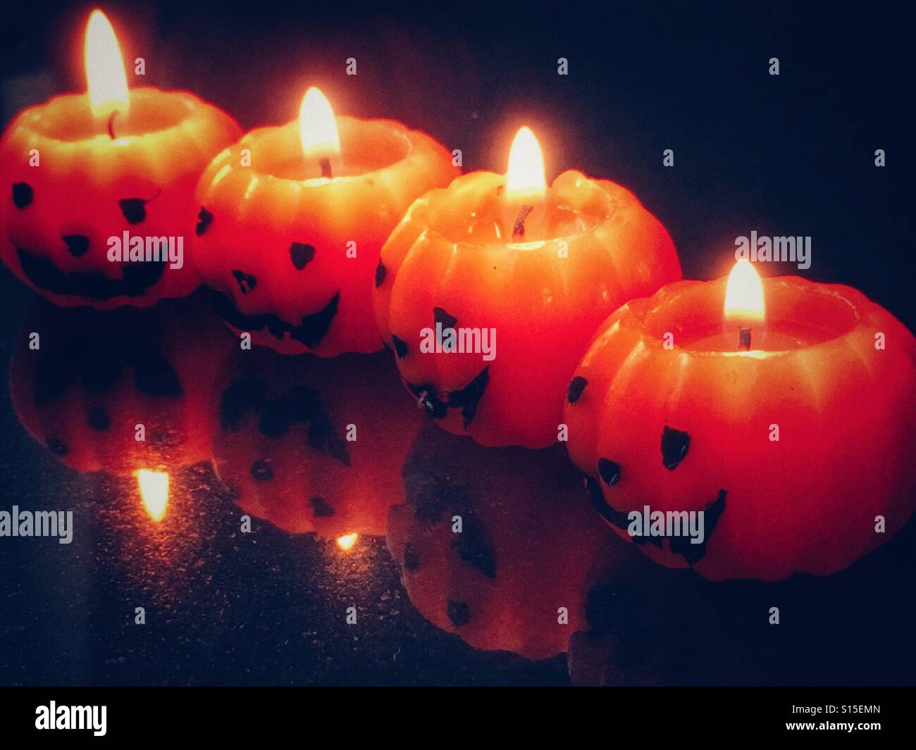 Halloween. Four pumpkin shaped candles - Smartphone Captured Stock Image