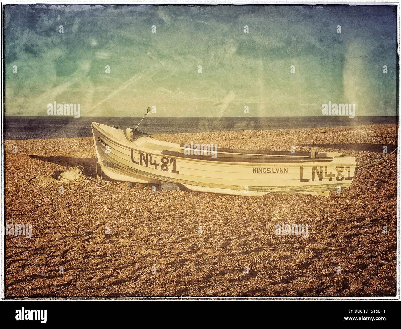 An Abandoned Boat lies on the beach in the Blakeney National Nature Reserve near Wells-Next-The-Sea in Norfolk, England. Photo Credit - © COLIN HOSKINS. - Smartphone Captured Stock Image