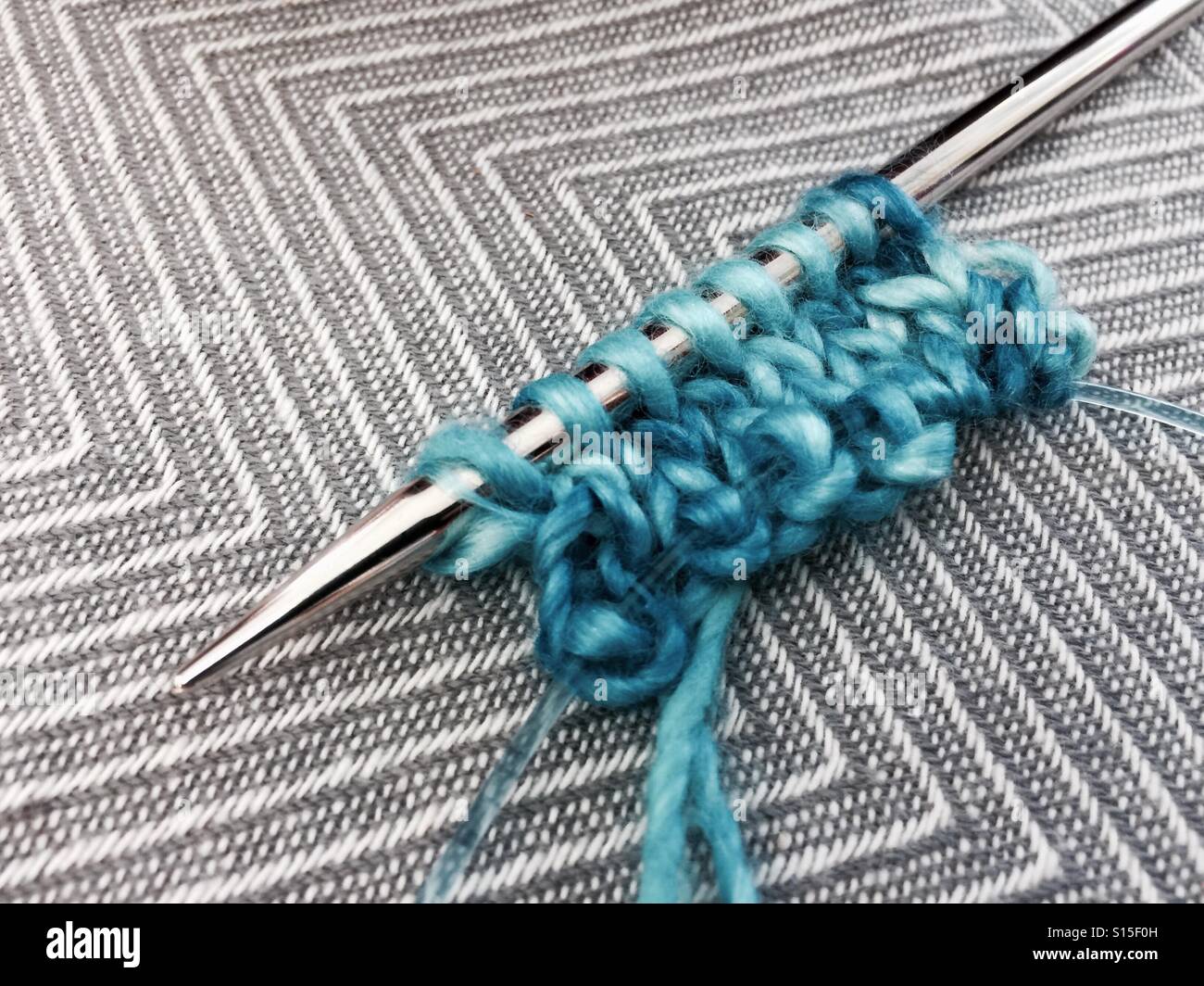 Blue knitting yarn on metal circular needle Stock Photo